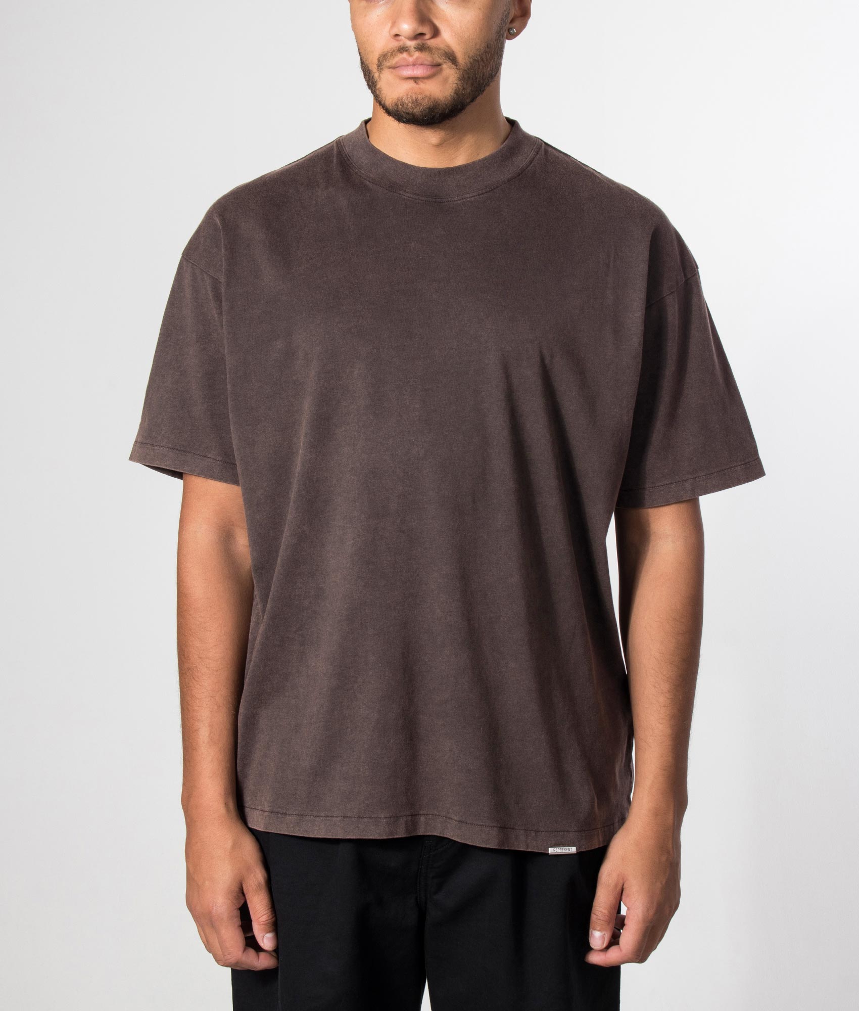 Represent Oversized Initial T-Shirt in  Coffee at EQVVS Menswear. Model front shot.