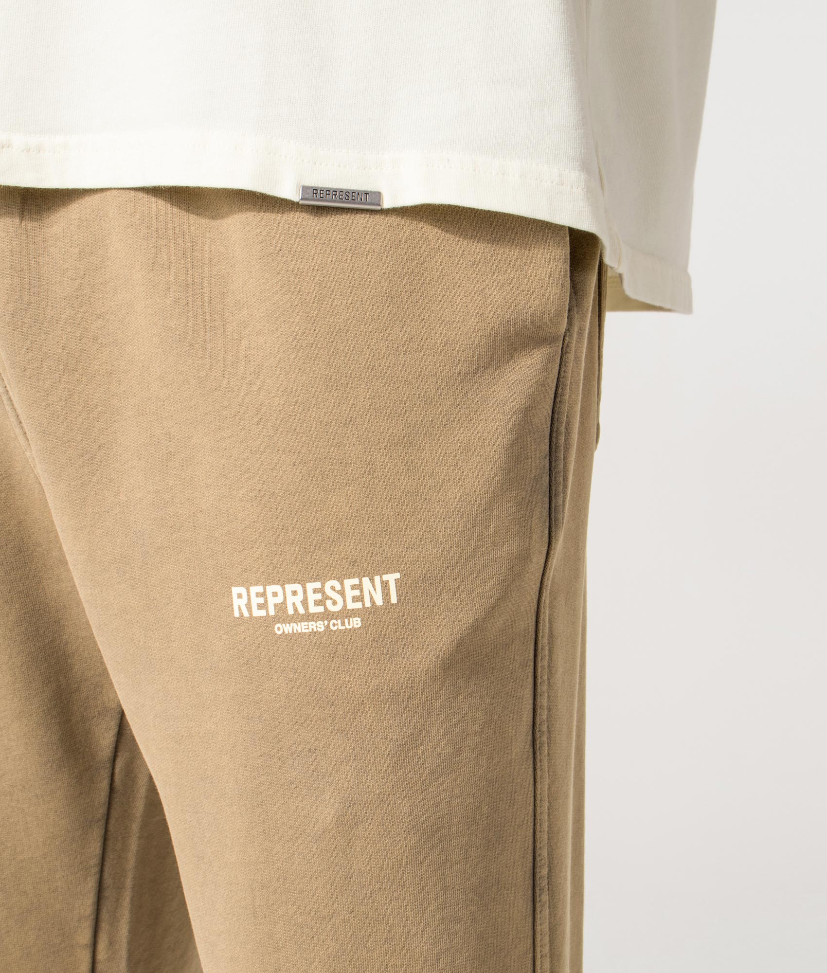 Owners’ Club Joggers in Almond | 100% Cotton | REPRESENT | EQVVS | Front detail model shot 