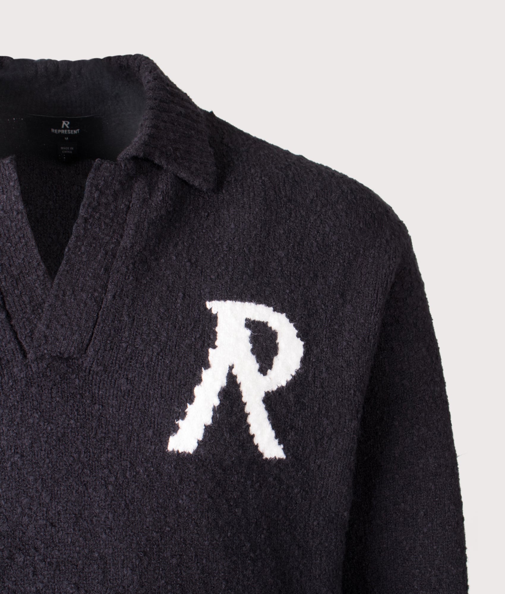 REPRESENT Knitted Boucle Long Sleeve Polo Shirt in Black at EQVVS Menswear.  Front detail shot.