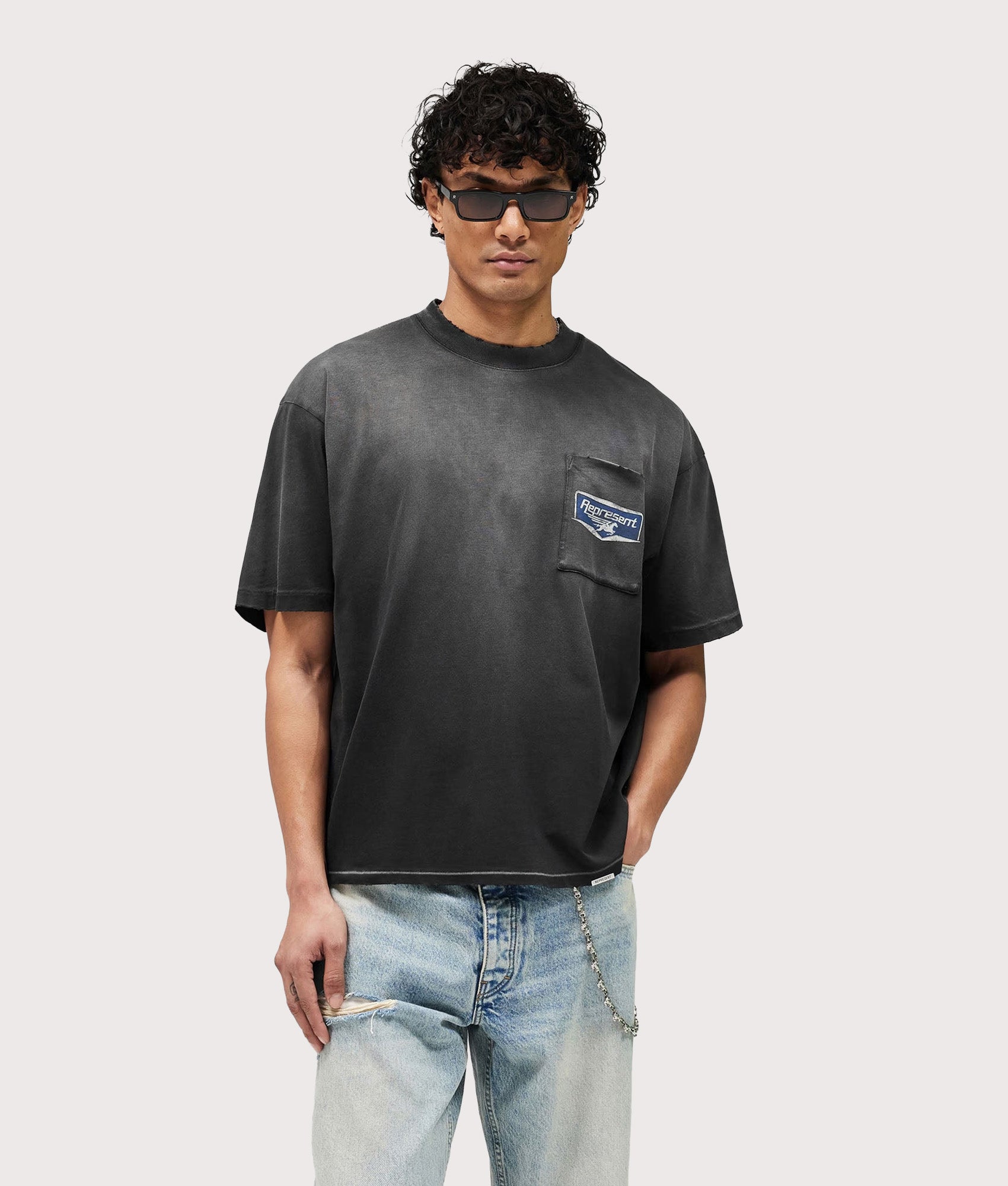 Represent Oversized Fit Nothing Faster T-Shirt in Stained Black at EQVVS Menswear. Model front shot.