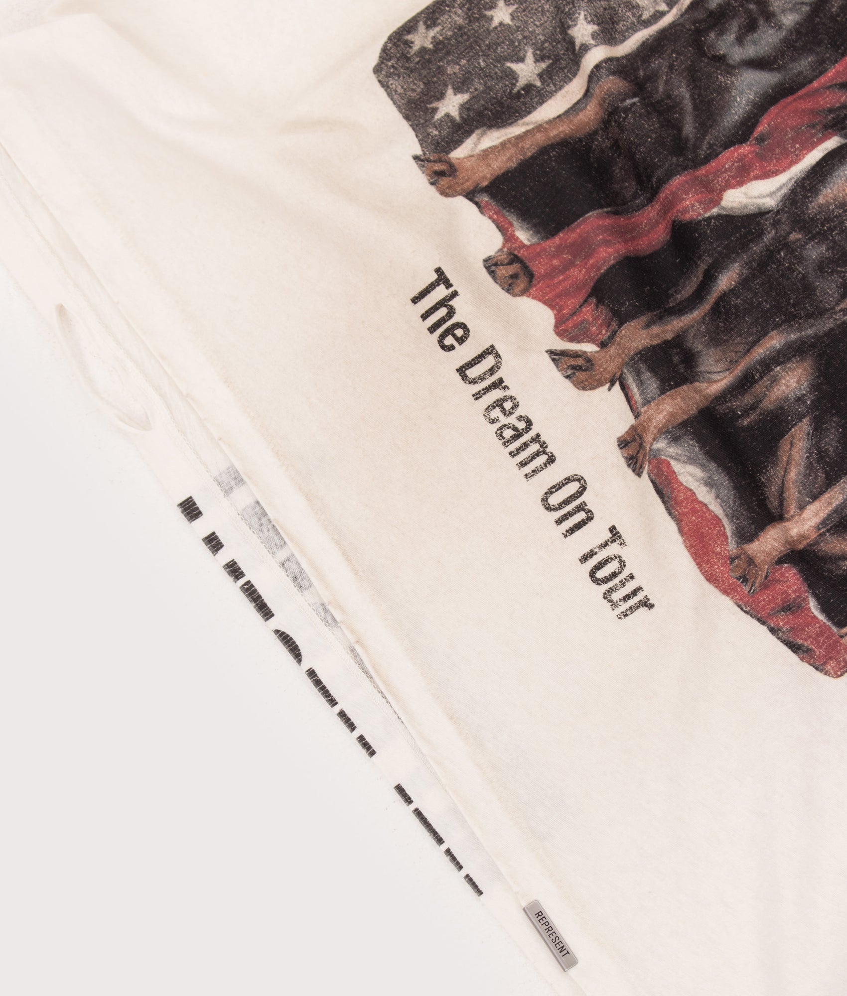 REPRESENT The American Dream On Tour T-Shirt in Washed Ecru at EQVVS Menswear. Detail shot.