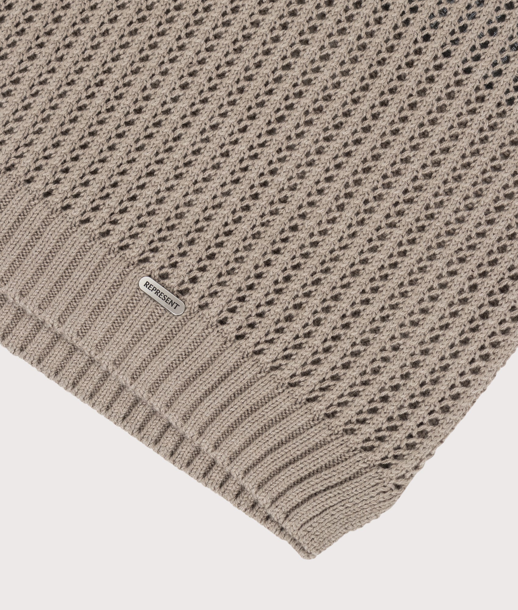 REPRESENT Beverly Open Gauge Knitted Polo Shirt in Vintage Khaki at EQVVS Menswear. Detail shot.