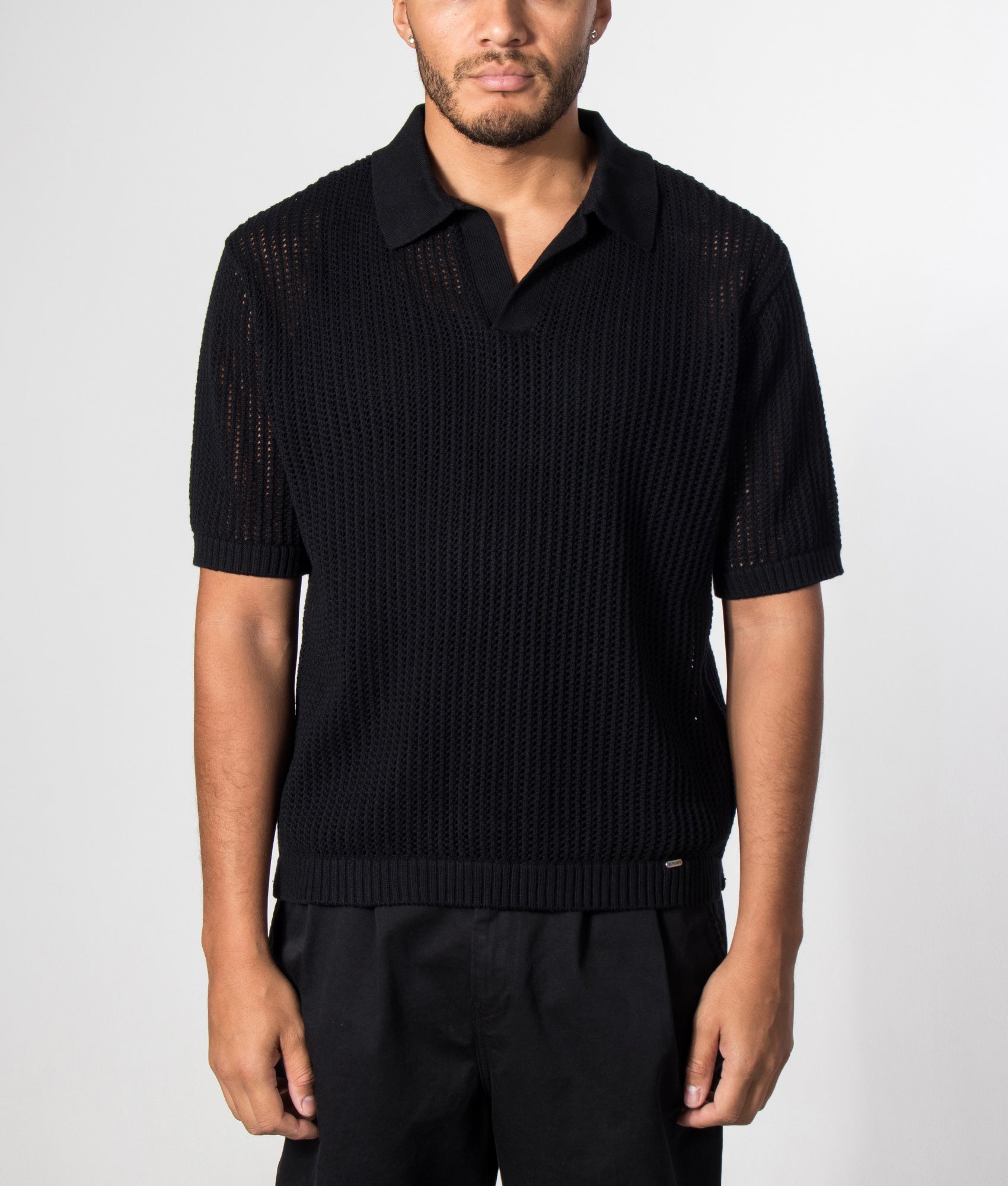 REPRESENT Beverly Open Gauge Knitted Polo Shirt in Jet Black at EQVVS Menswear. Model front shot vest.