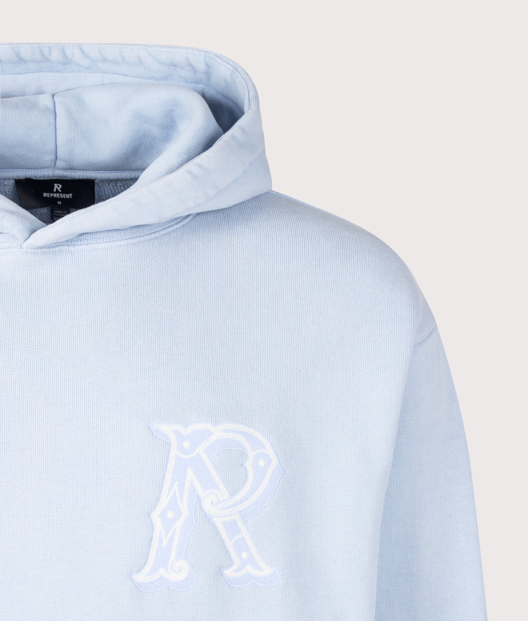 REPRESENT Western Initial Hoodie in Mountain Bluebird at EQVVS Menswear. Detail shot.