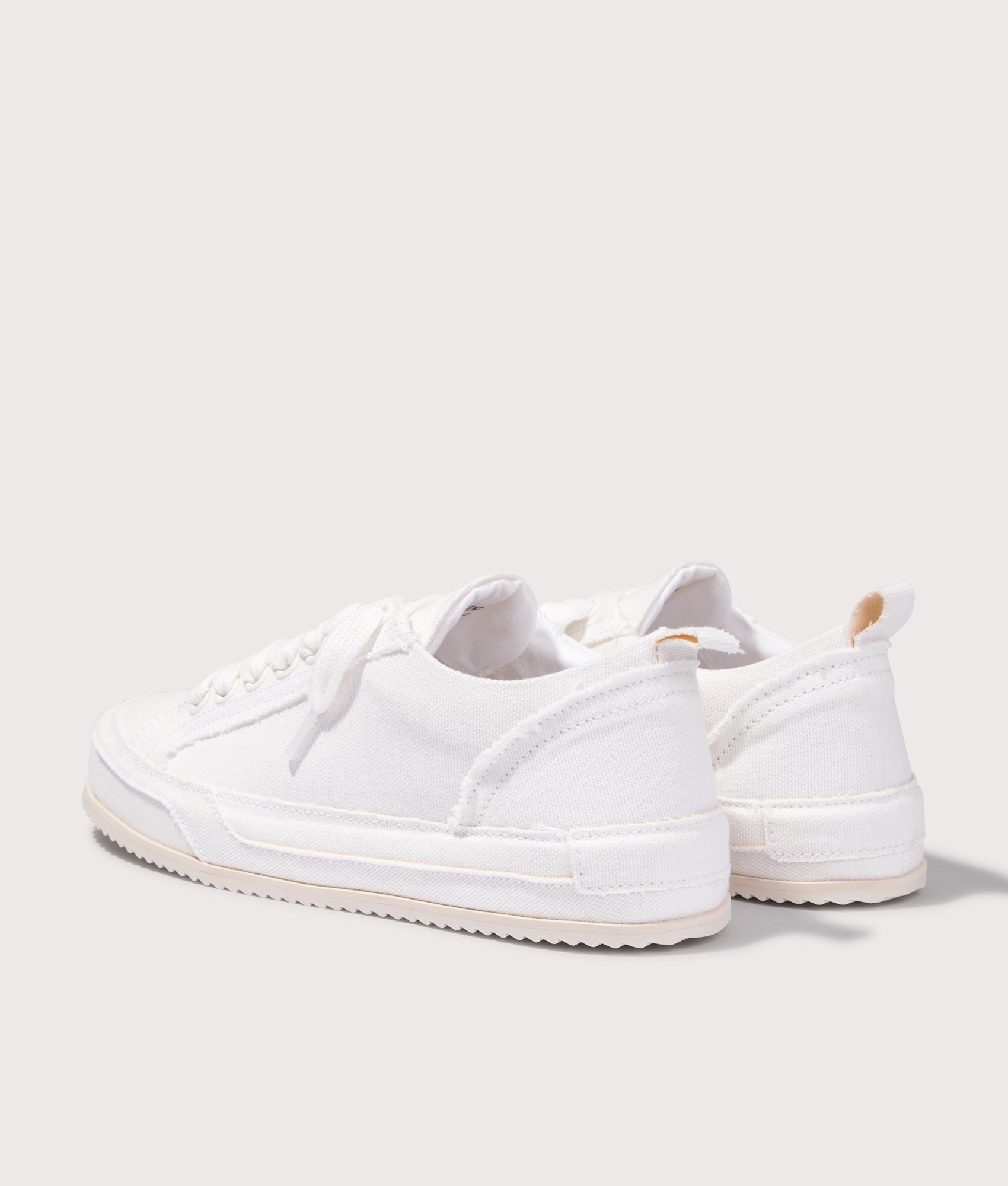 REPRESENT Alpha Wrap Canvas Trainers in Vintage White at EQVVS Menswear. Angled back shot.