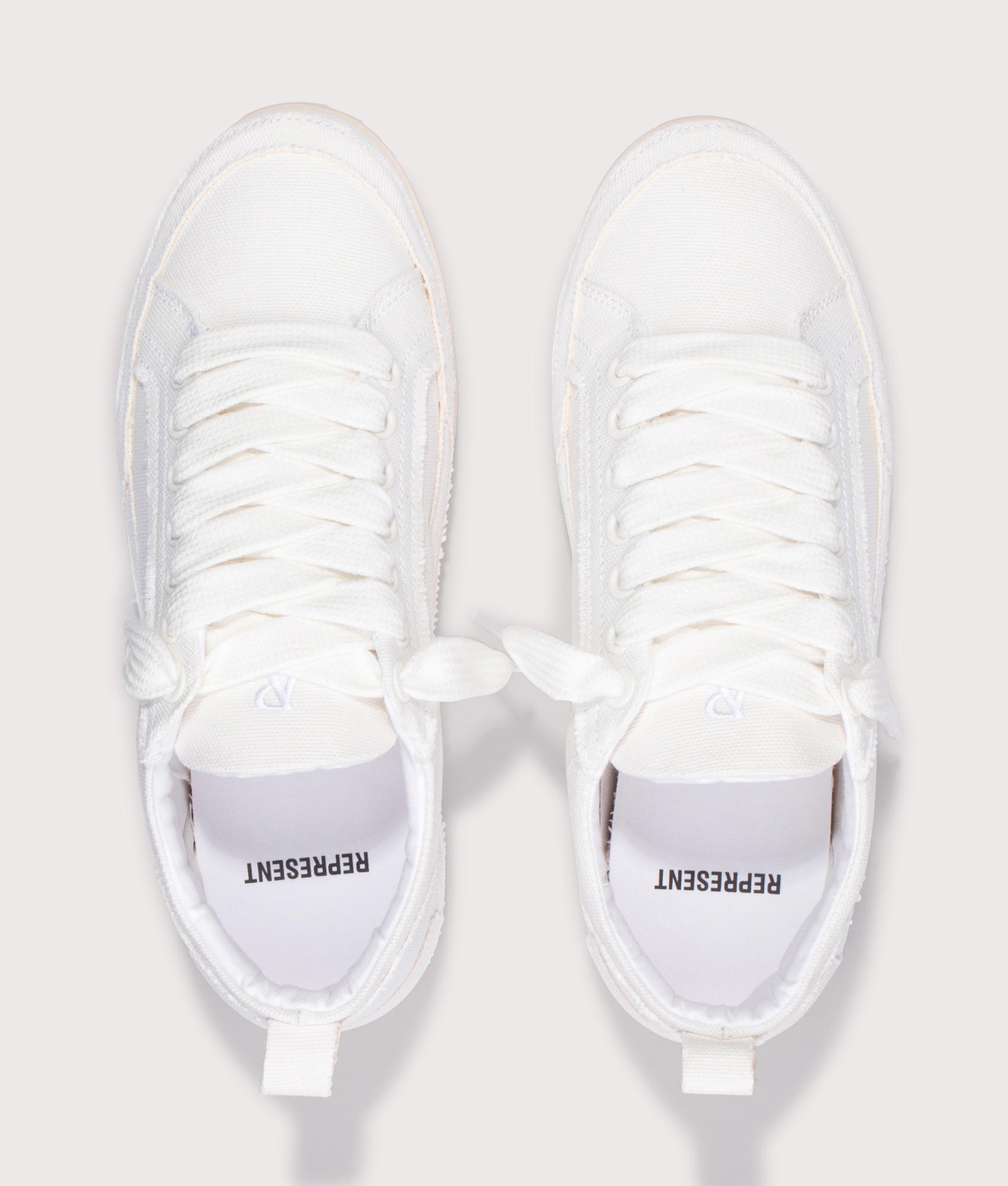 REPRESENT Alpha Wrap Canvas Trainers in Vintage White at EQVVS Menswear. Top shot.