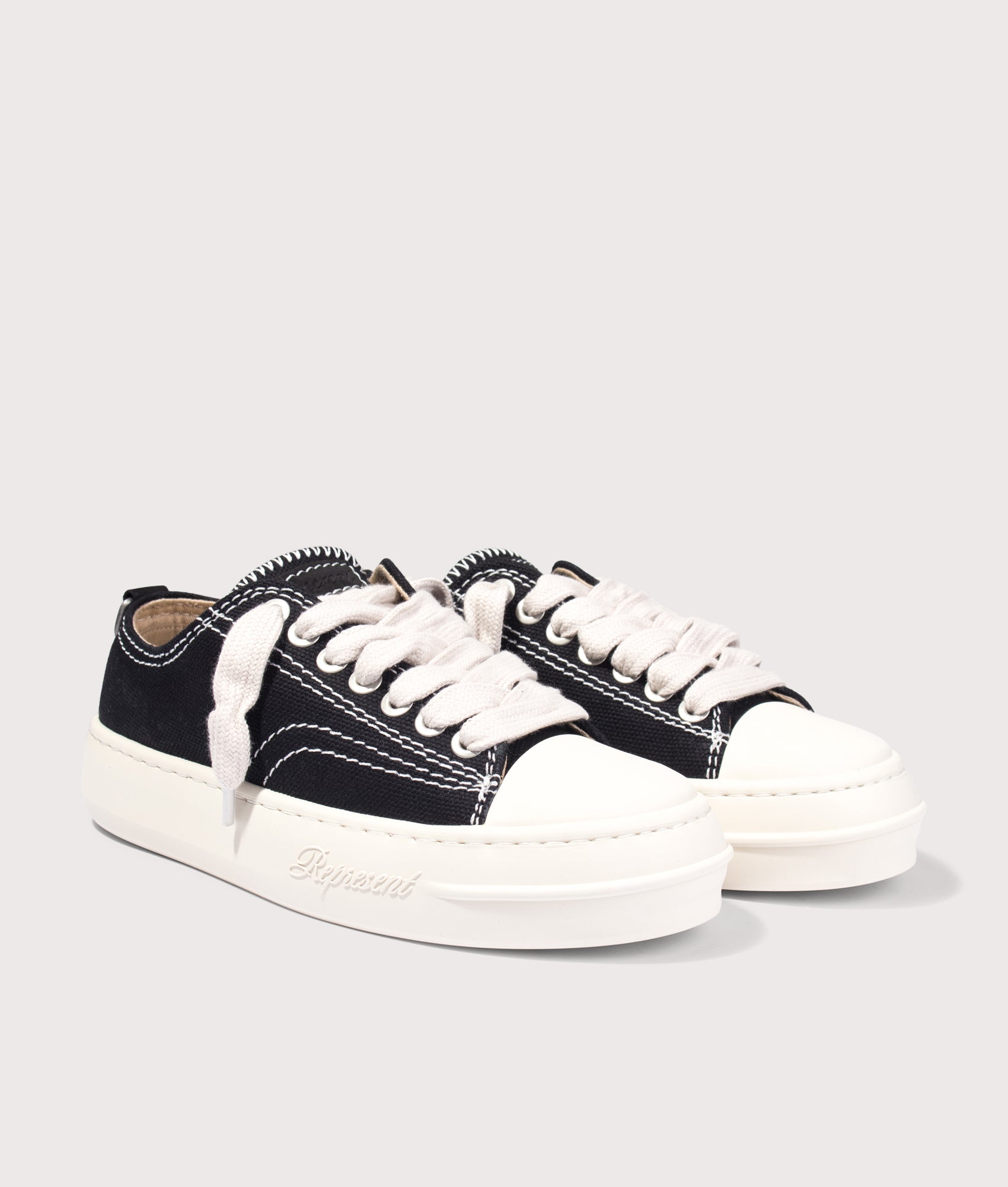 Rep Cap Trainers in Jet Black by Represent. Shot by EQVVS. Front angled shot.