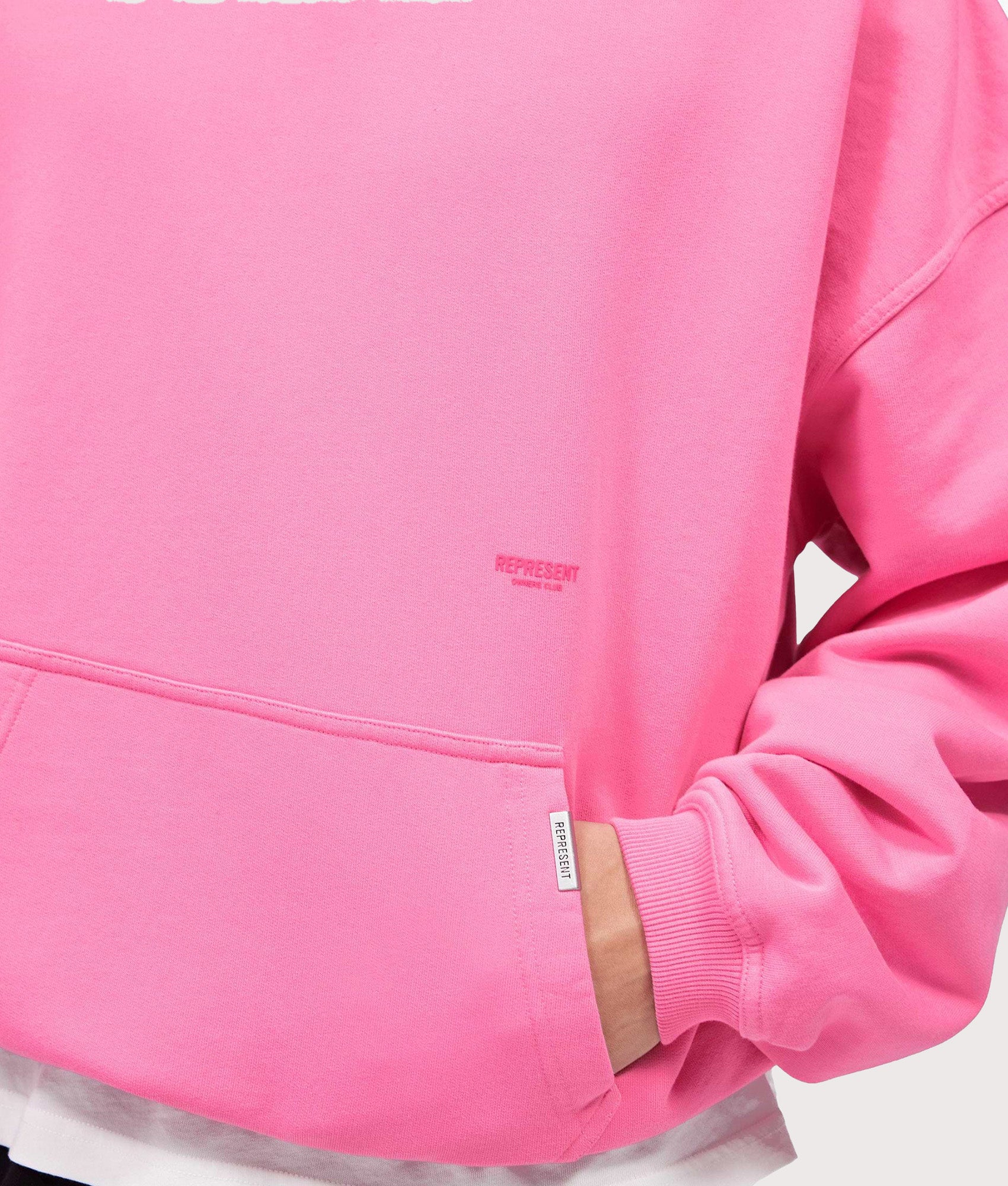 Represent Oversized Micro Owners Club Hoodie in Pink at EQVVS Menswear. Detail shot.