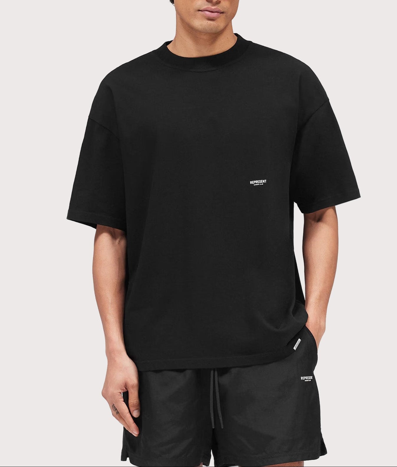 Represent Oversized Micro Owners Club T-Shirt in Jet Black at EQVVS Menswear. Model front shot.