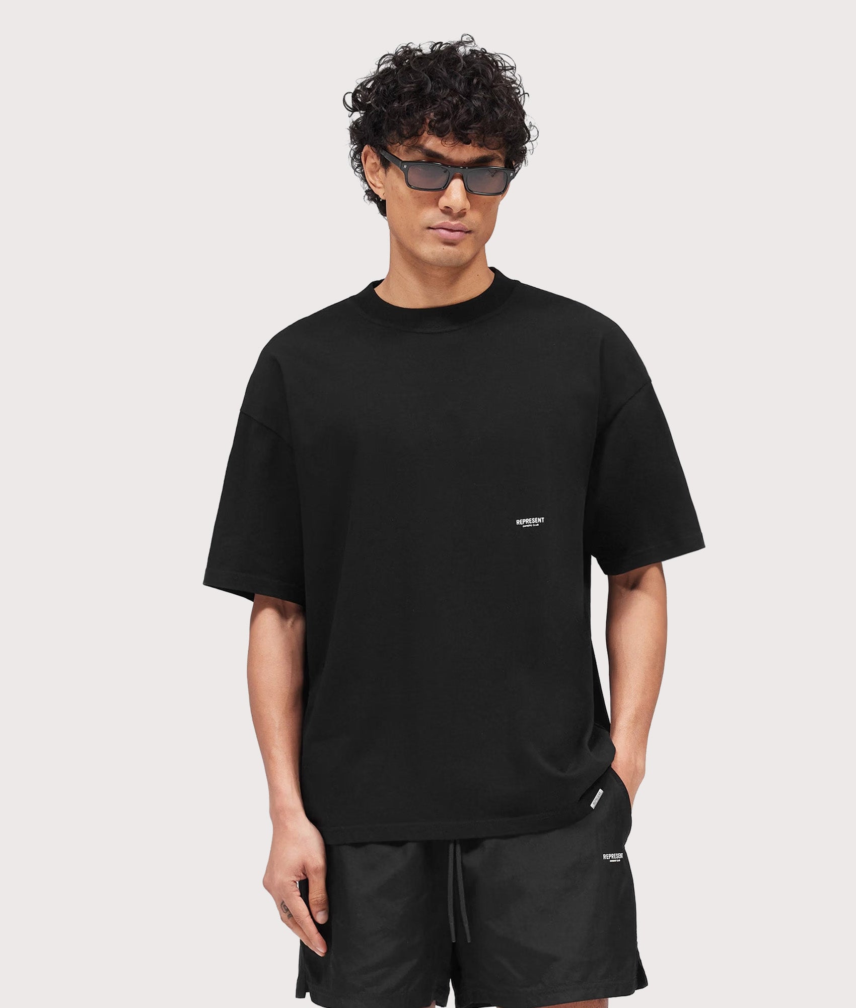 Represent Oversized Micro Owners Club T-Shirt in Jet Black at EQVVS Menswear. Model front shot.