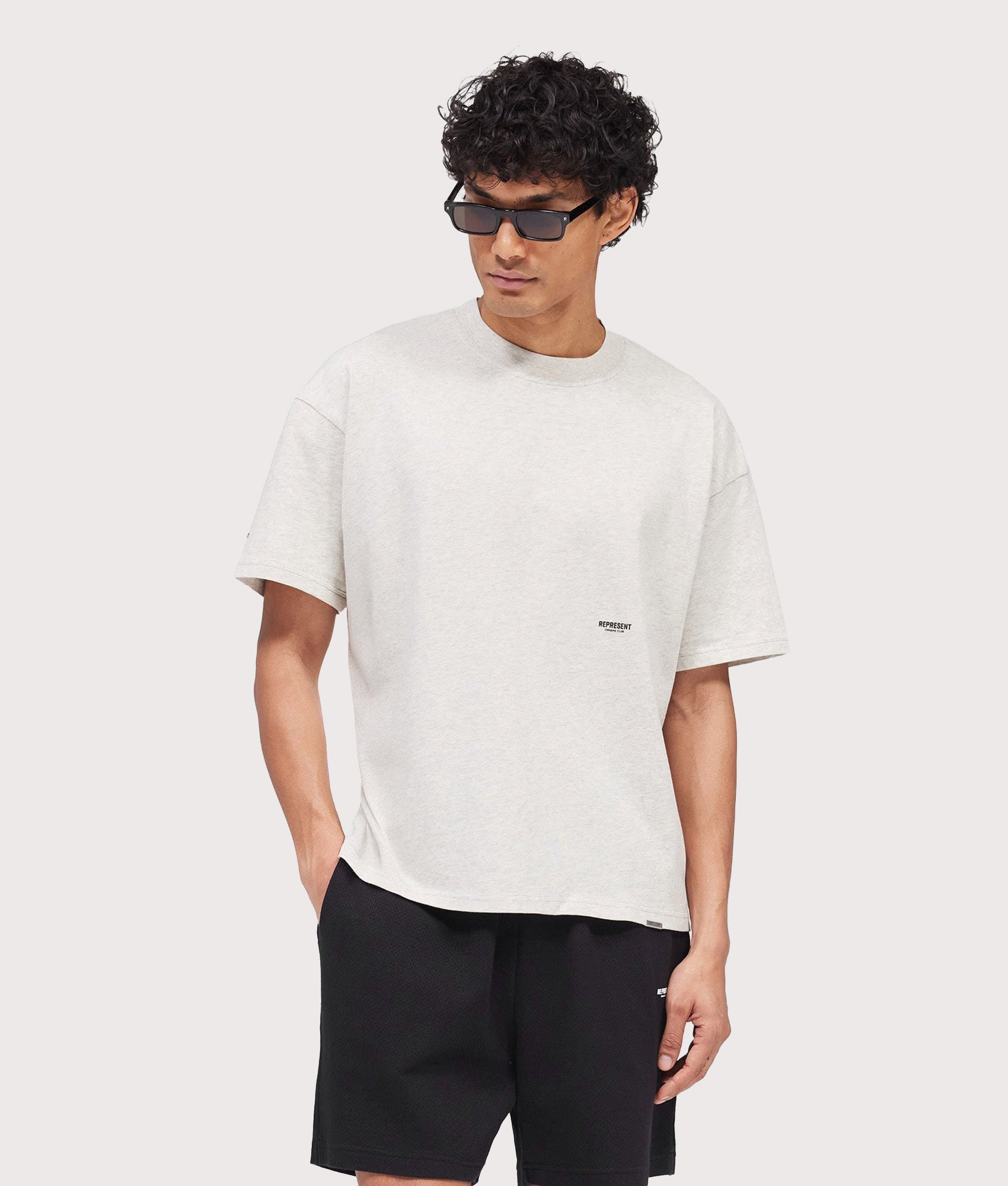 Represent Oversized Micro Owners Club T-Shirt in Cream Marl at EQVVS Menswear. Model front shot.