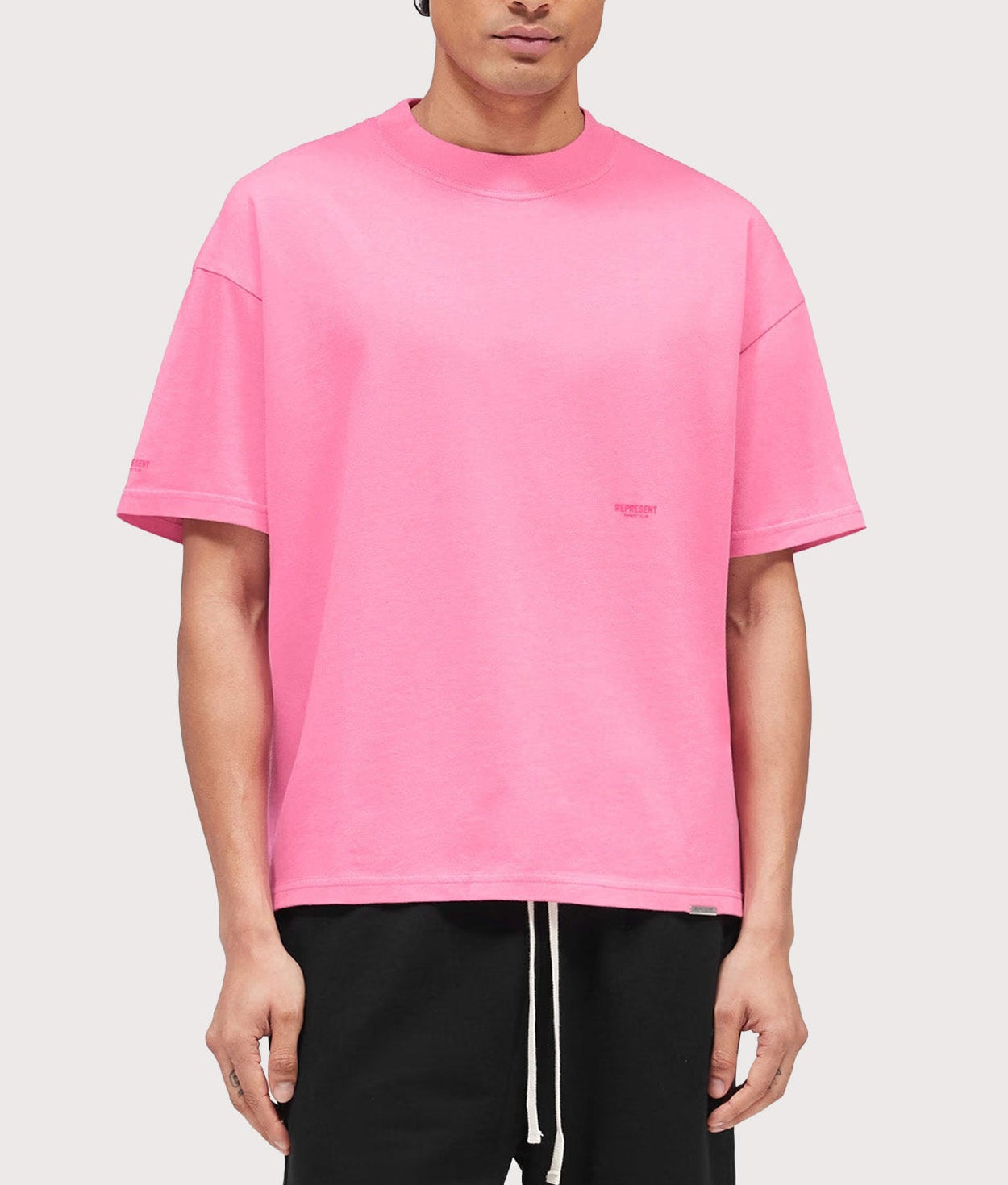 Represent Oversized Micro Owners Club T-Shirt in Pink at EQVVS Menswear. Model front shot.