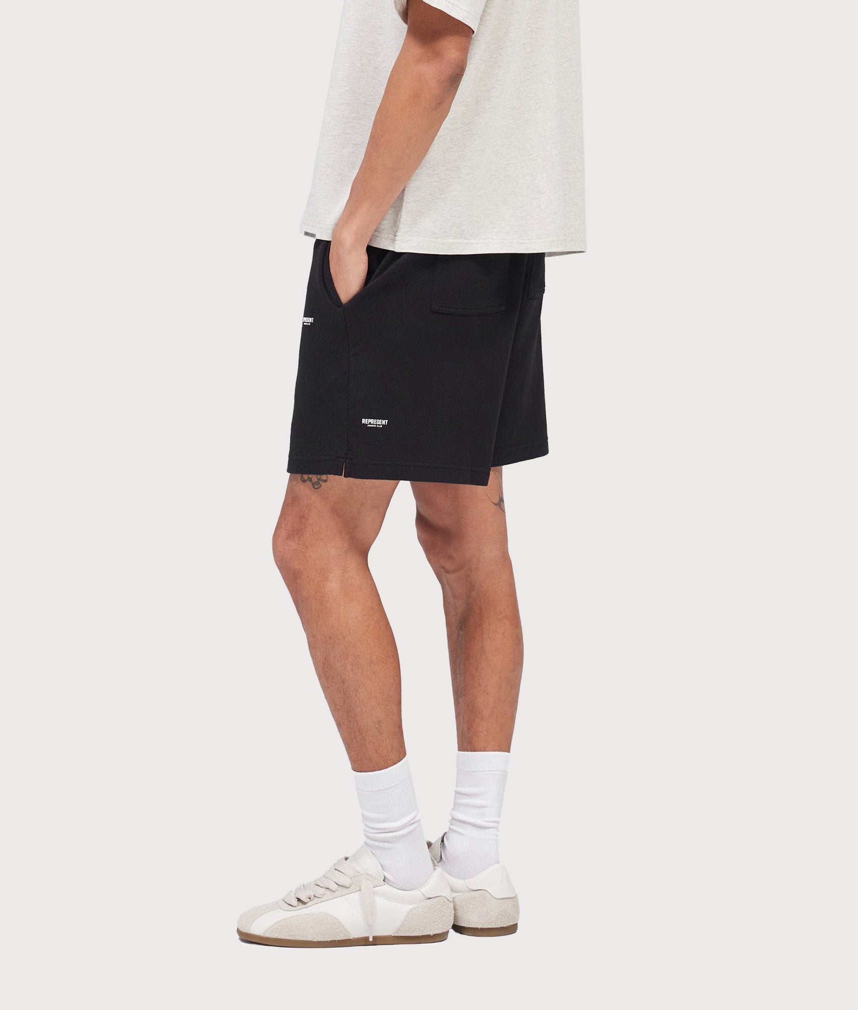 Represent Relaxed fit Micro Owners Club Shorts in Black at EQVVS Menswear. Model side shot.