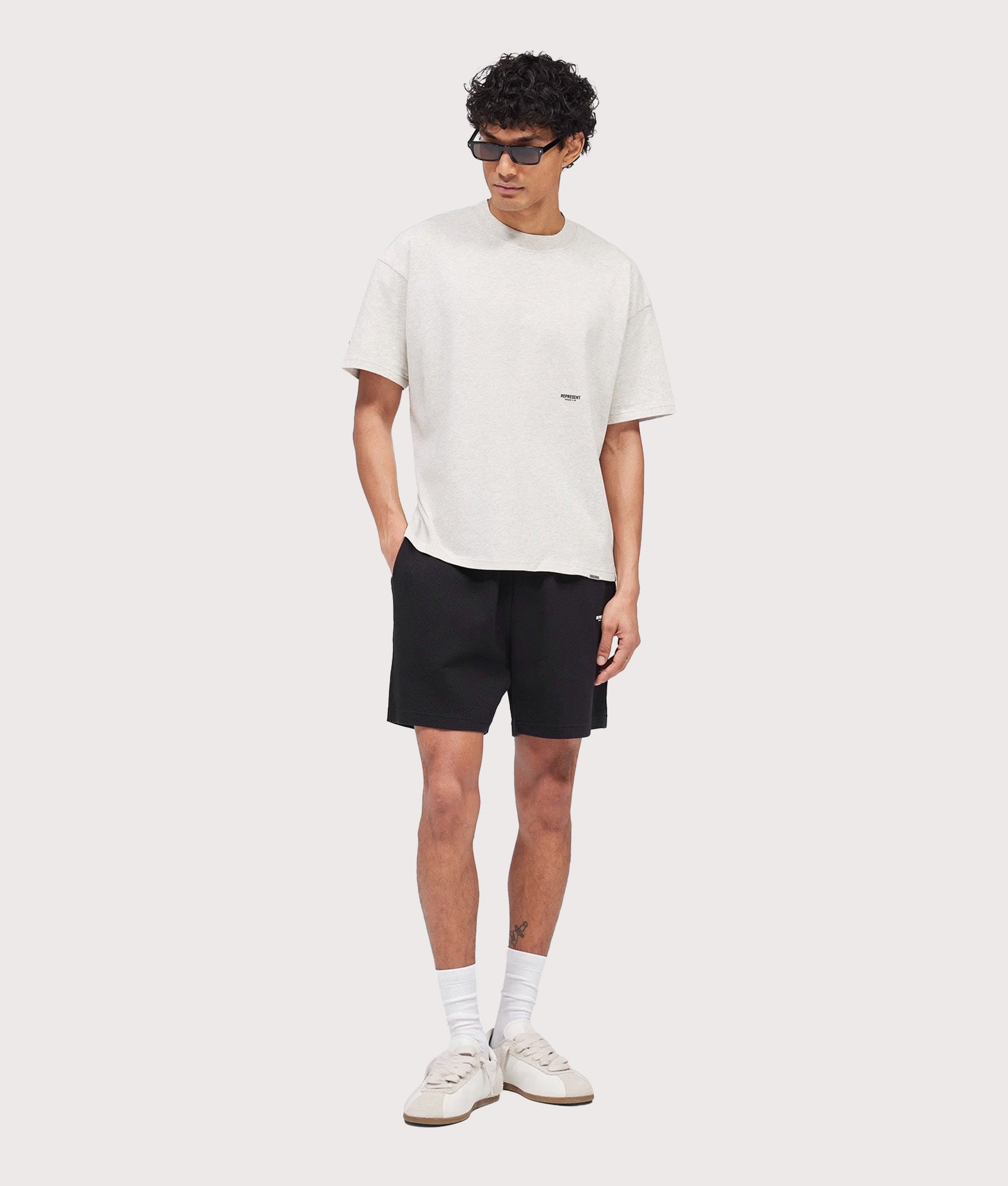Represent Relaxed fit Micro Owners Club Shorts in Black at EQVVS Menswear. Model full front shot.