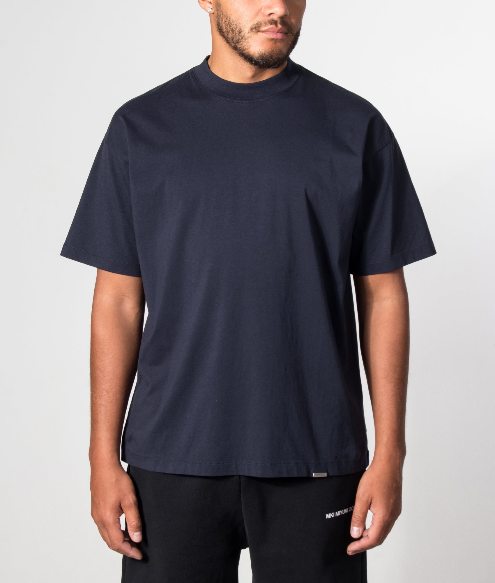 Represent Oversized Initial T-Shirt in Midnight Navy at EQVVS Menswear. Model front shot.