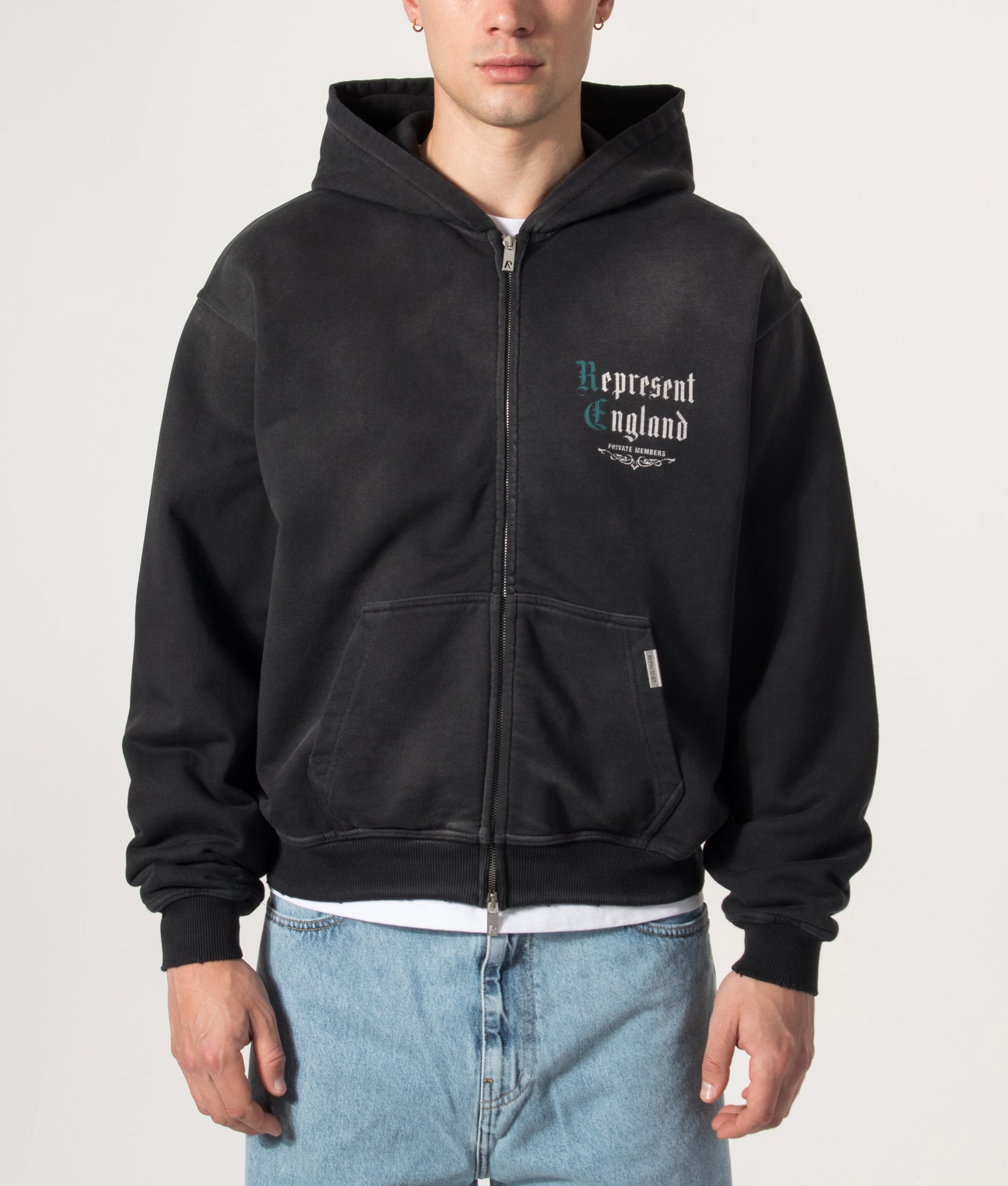 Represent Oversized Fit Private Members Hoodie in Stained Black at EQVVS Menswear. Model front shot.