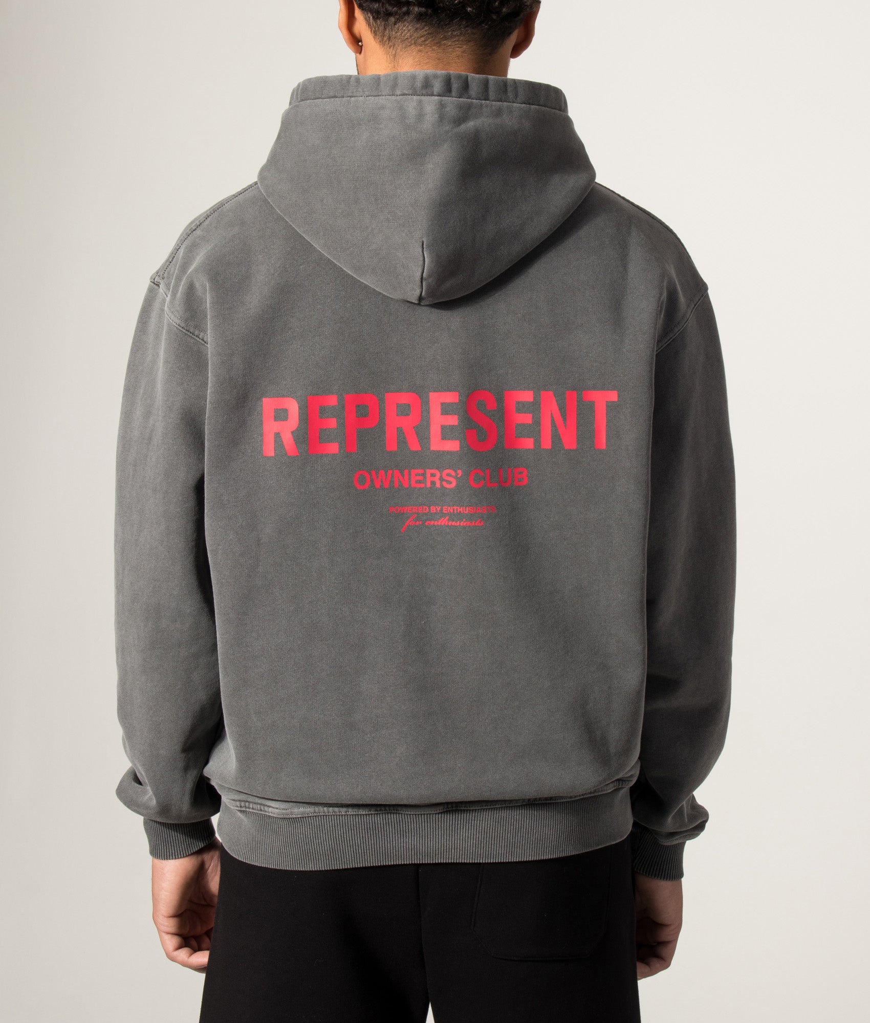 Represent Oversized Fit Represent Owners Club Hoodie in Washed Black at EQVVS Menswear. Model back shot.