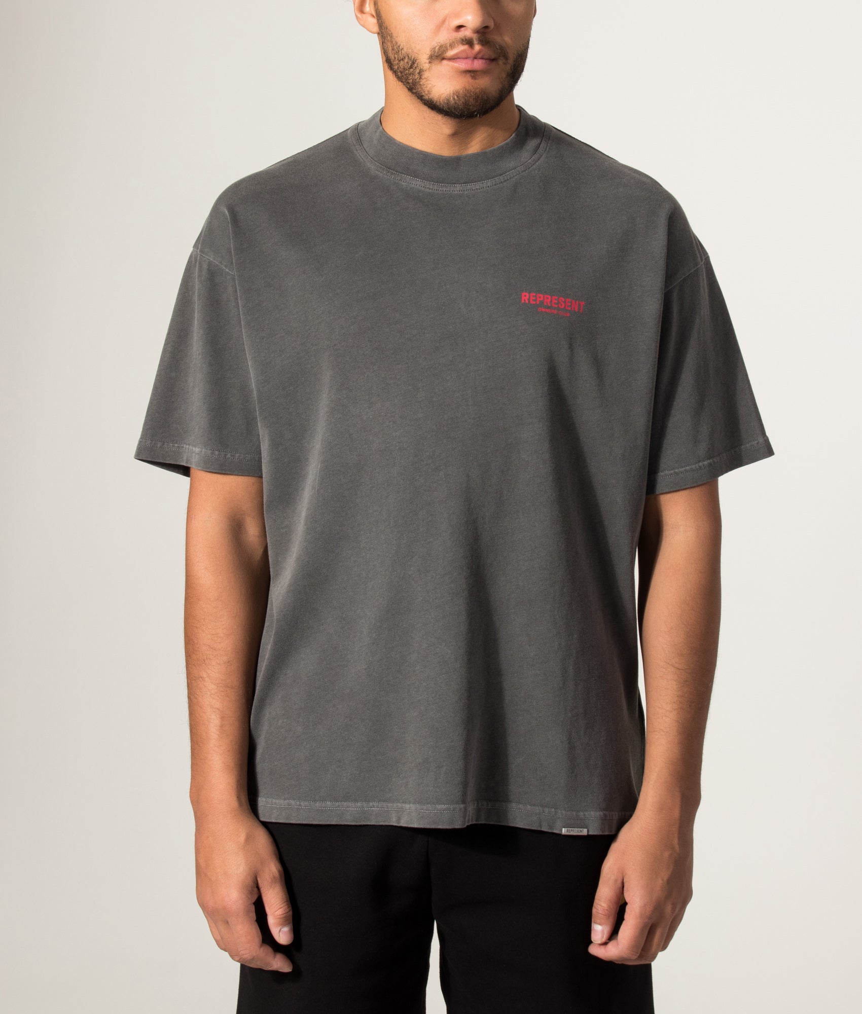 Represent Oversized Fit Represent Owners Club T-Shirt in Washed Black at EQVVS Menswear. Model front shot.