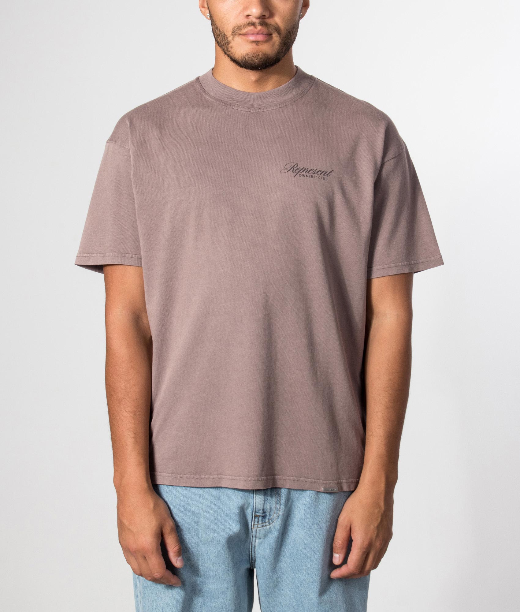 Represent Oversized Fit Represent Owners Club Script T-Shirt in Truffle at EQVVS Menswear. Model front shot.
