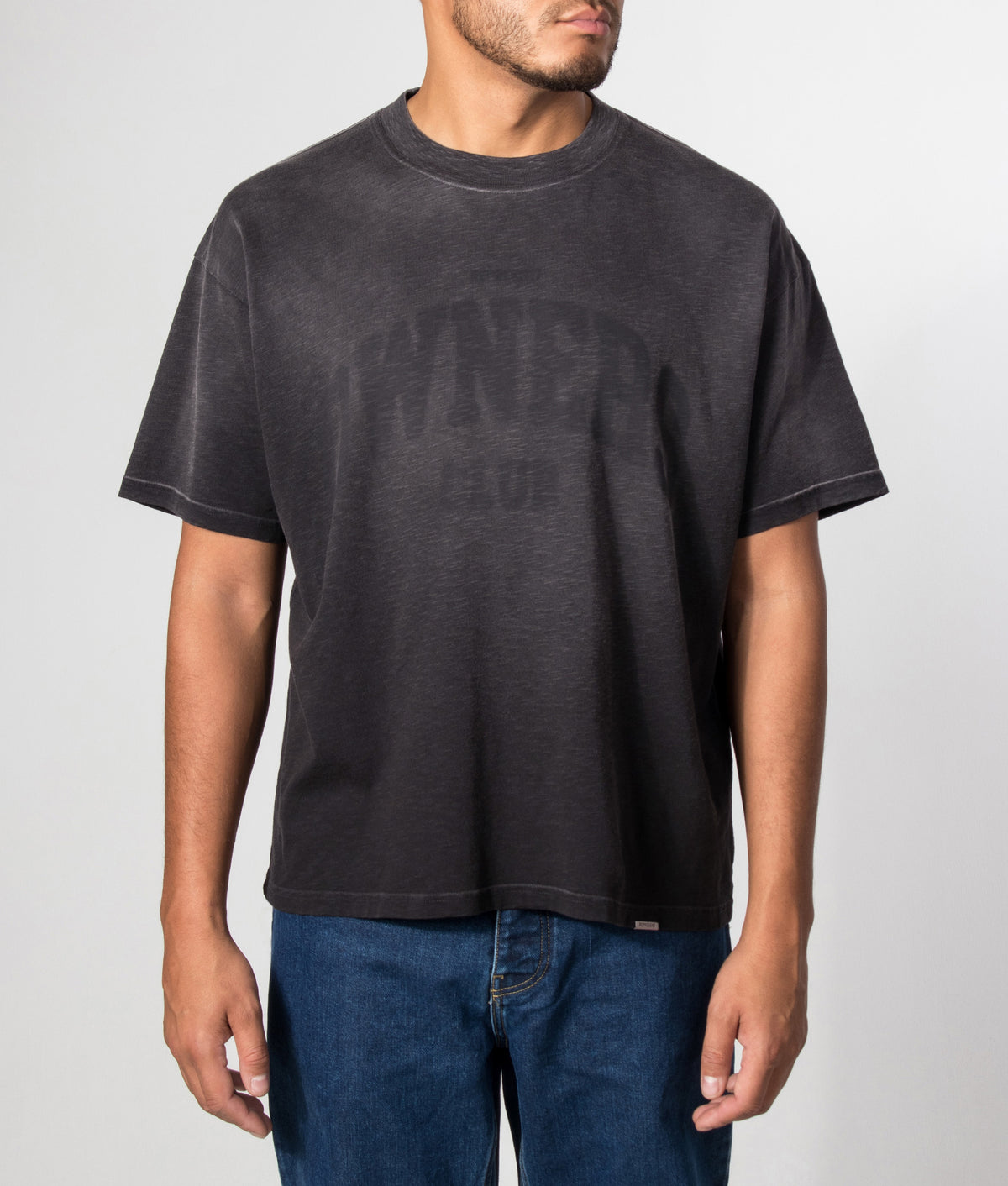 Represent Oversized Fit Owners T-Shirt in Vintage Black at EQVVS Menswear. Model front shot.