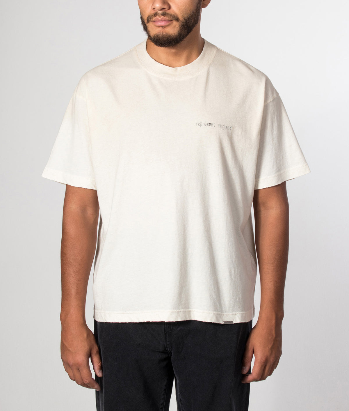 REPRESENT Oversized Box Fit Reverse Resent T-Shirt in Flat White at EQVVS Menswear. Model front shot.