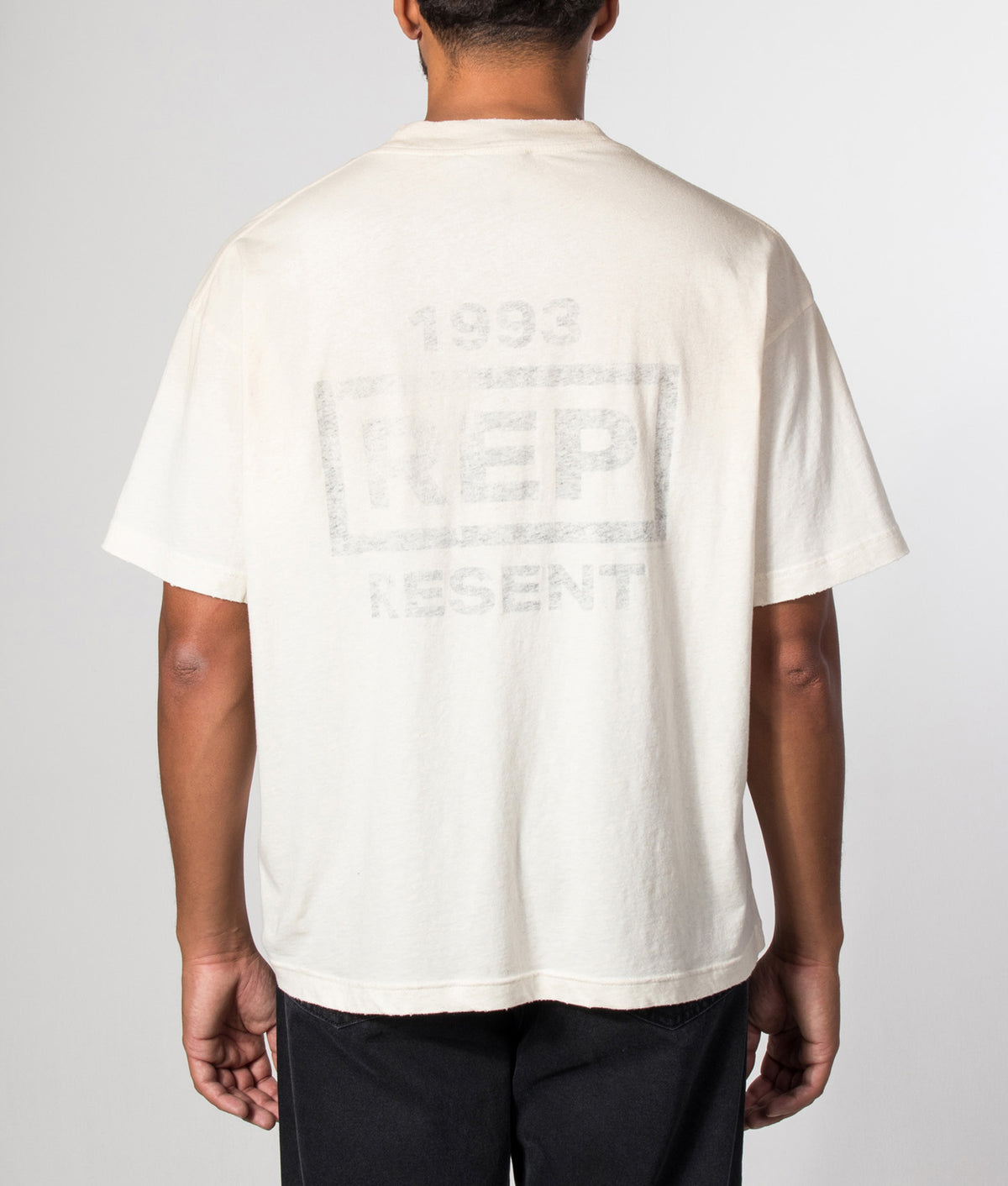 REPRESENT Oversized Box Fit Reverse Resent T-Shirt in Flat White at EQVVS Menswear. Model back shot.