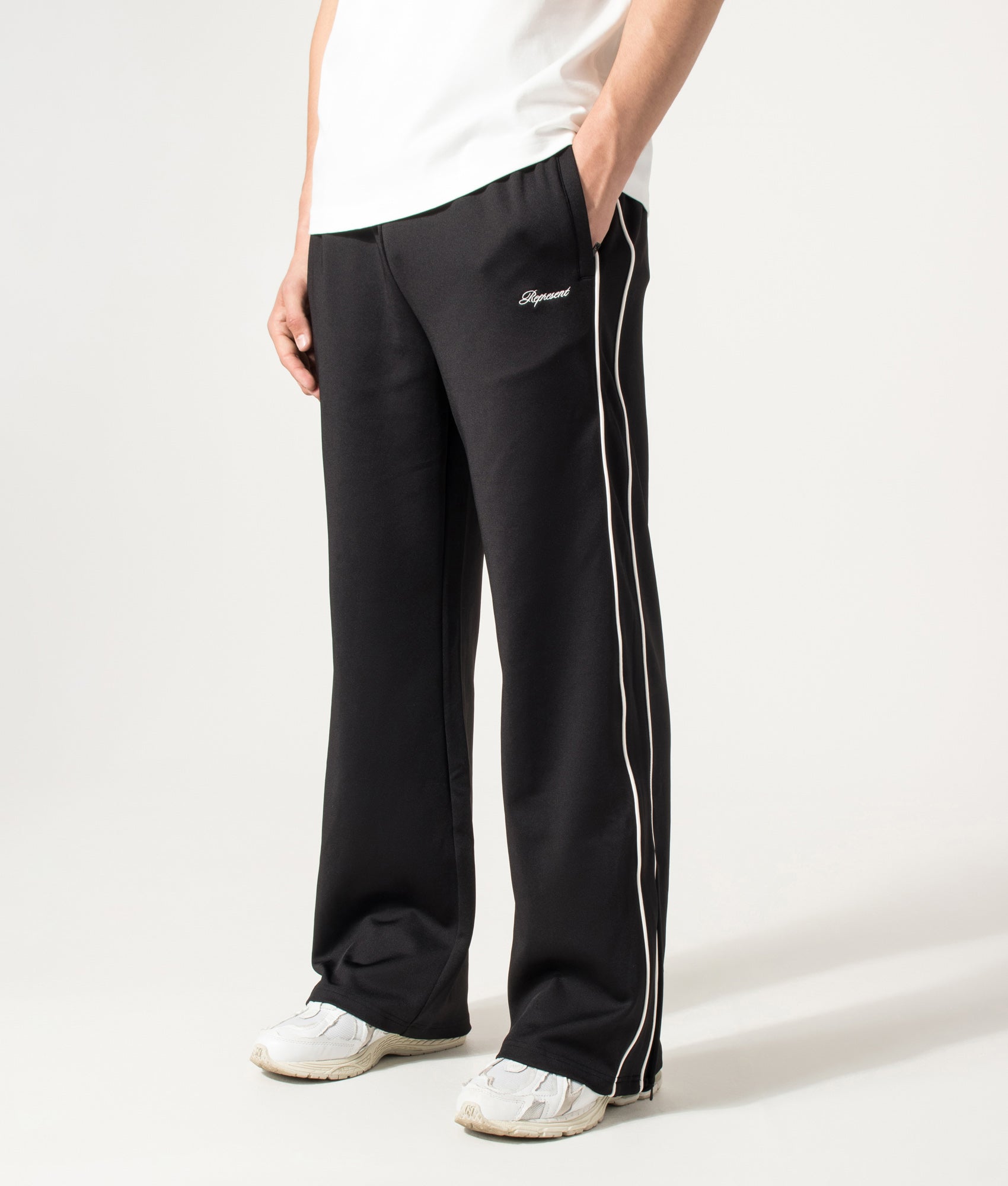 Represent Taped Track Pant in Black at EQVVS Menswear. Angled model front shot.