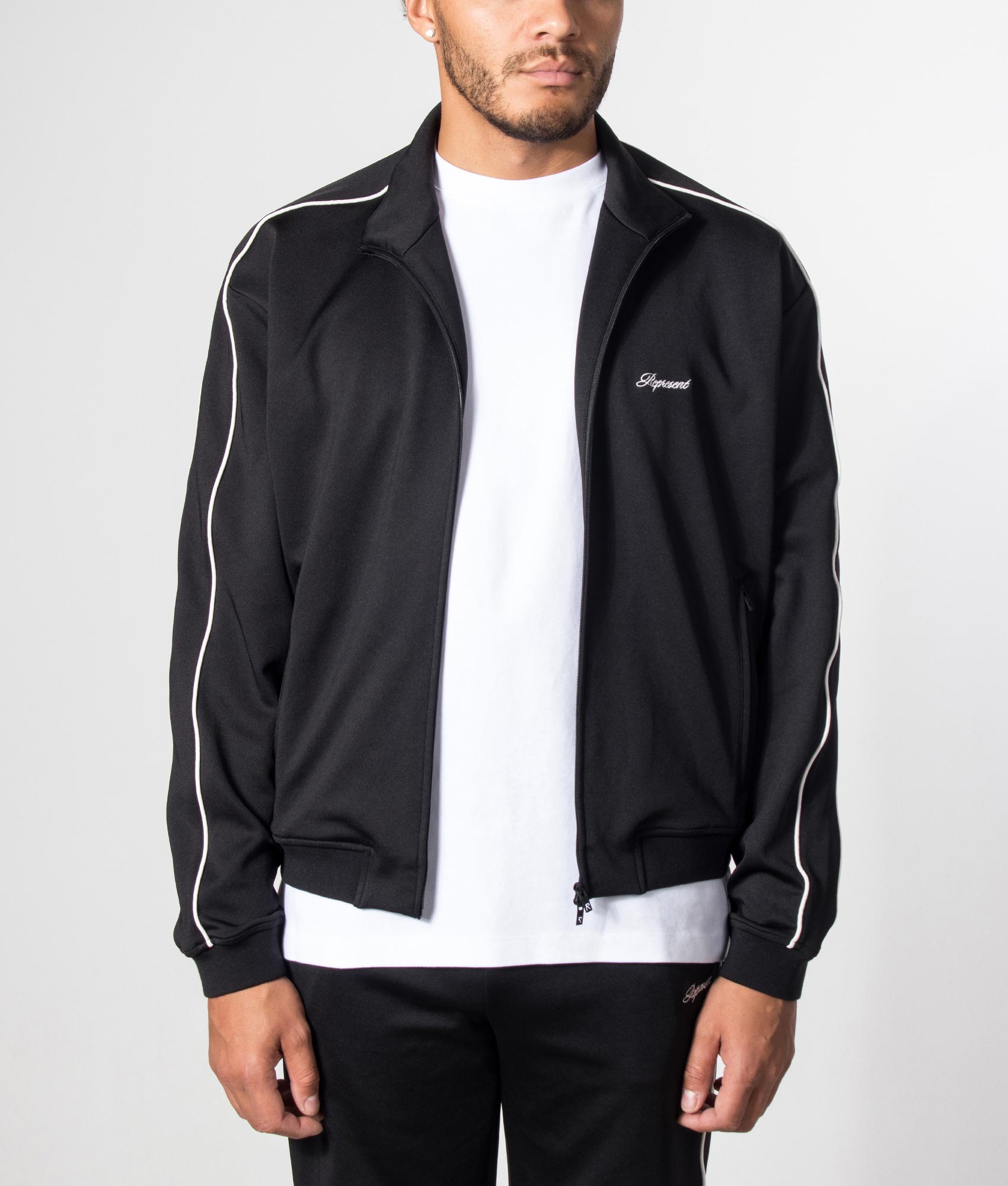 Represent Taped Track Top in Black at EQVVS menswear. Model shot.