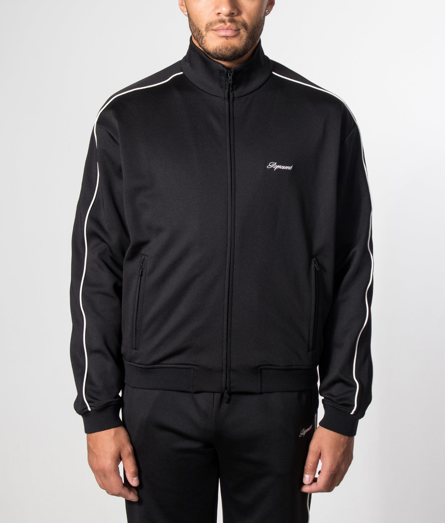 Represent Taped Track Top in Black at EQVVS menswear. Model front shot.