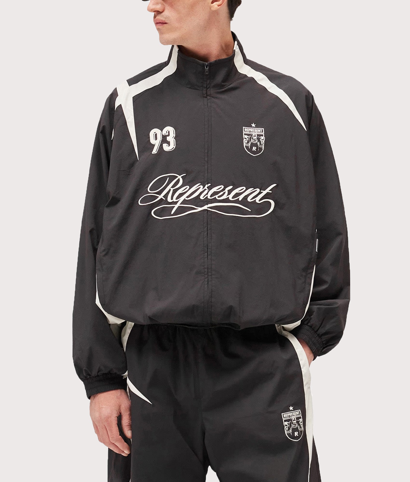 Represent Woven Track Star Jacket in Jet Black at EQVVS Menswear. Model front shot.
