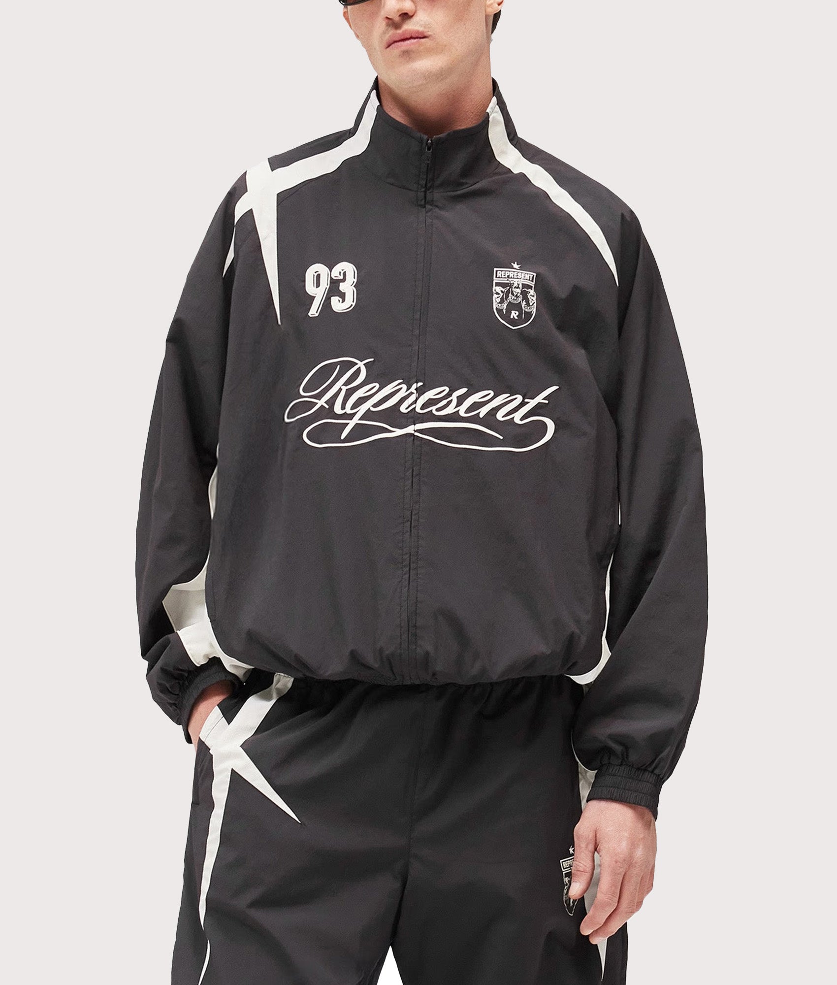 Represent Woven Track Star Jacket in Jet Black at EQVVS Menswear. Model front shot.