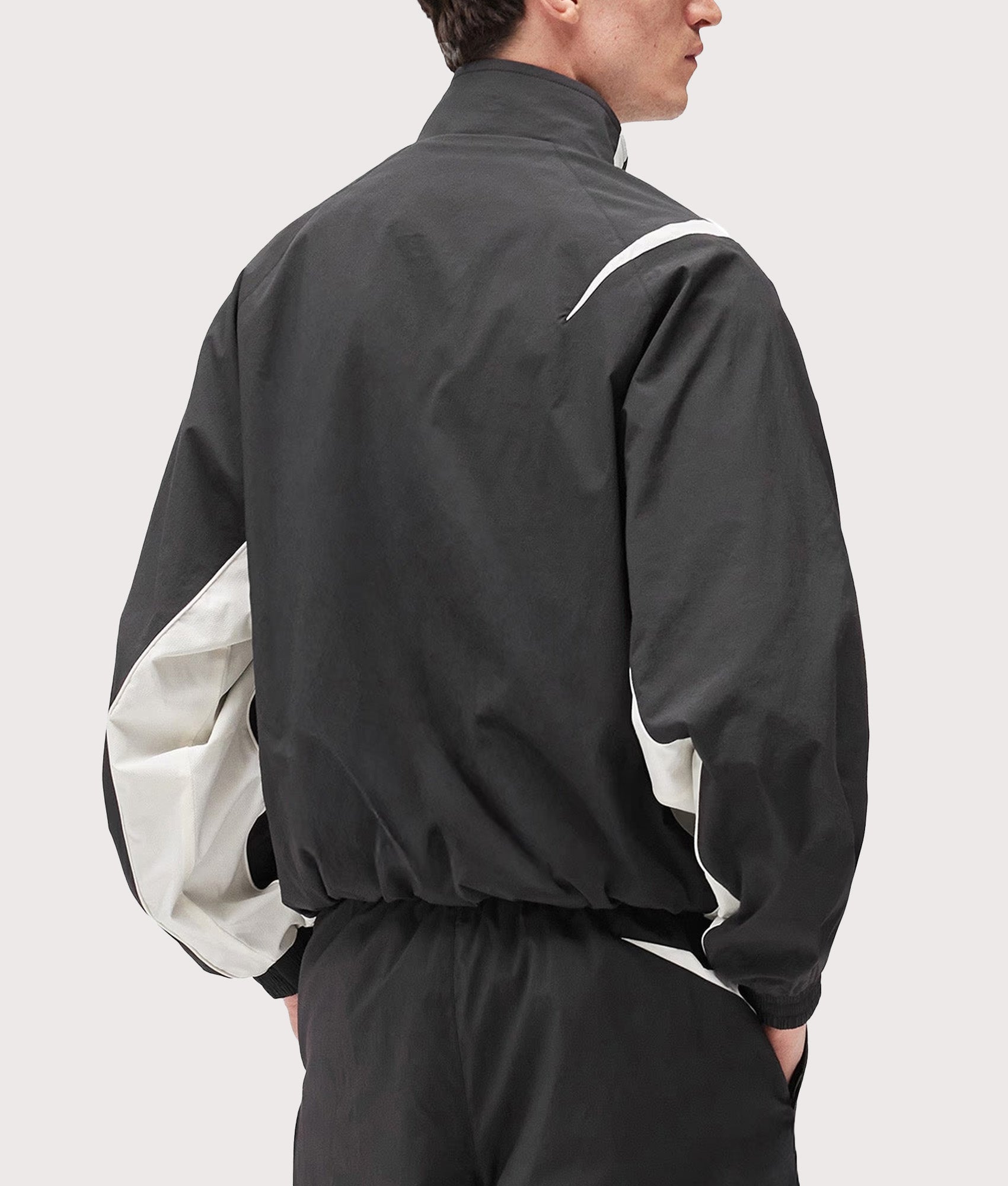 Represent Woven Track Star Jacket in Jet Black at EQVVS Menswear. Model back shot.