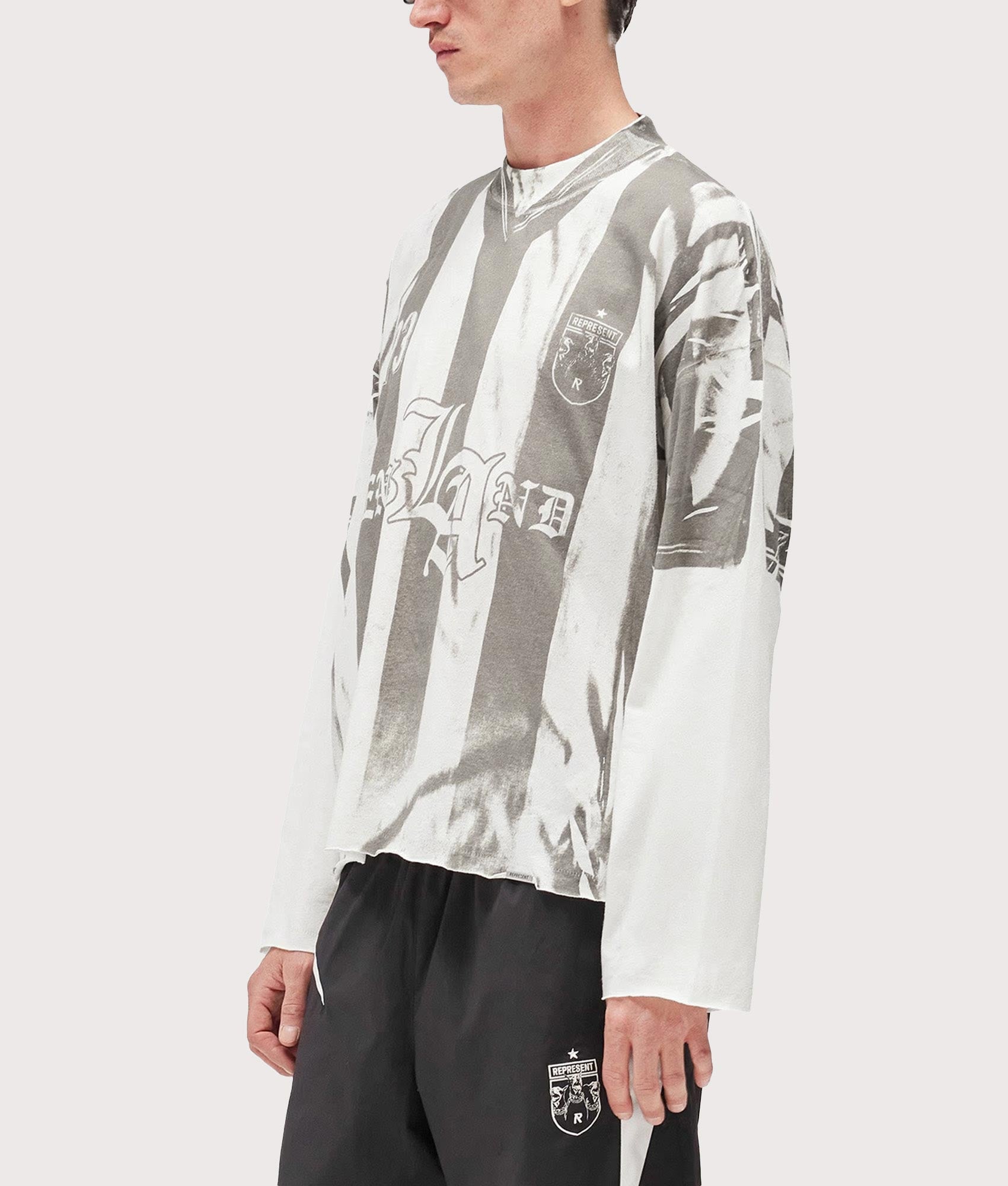 Represent Oversized Fit Printed LS Football Top in Flat White at EQVVS Menswear. Angled front shot.