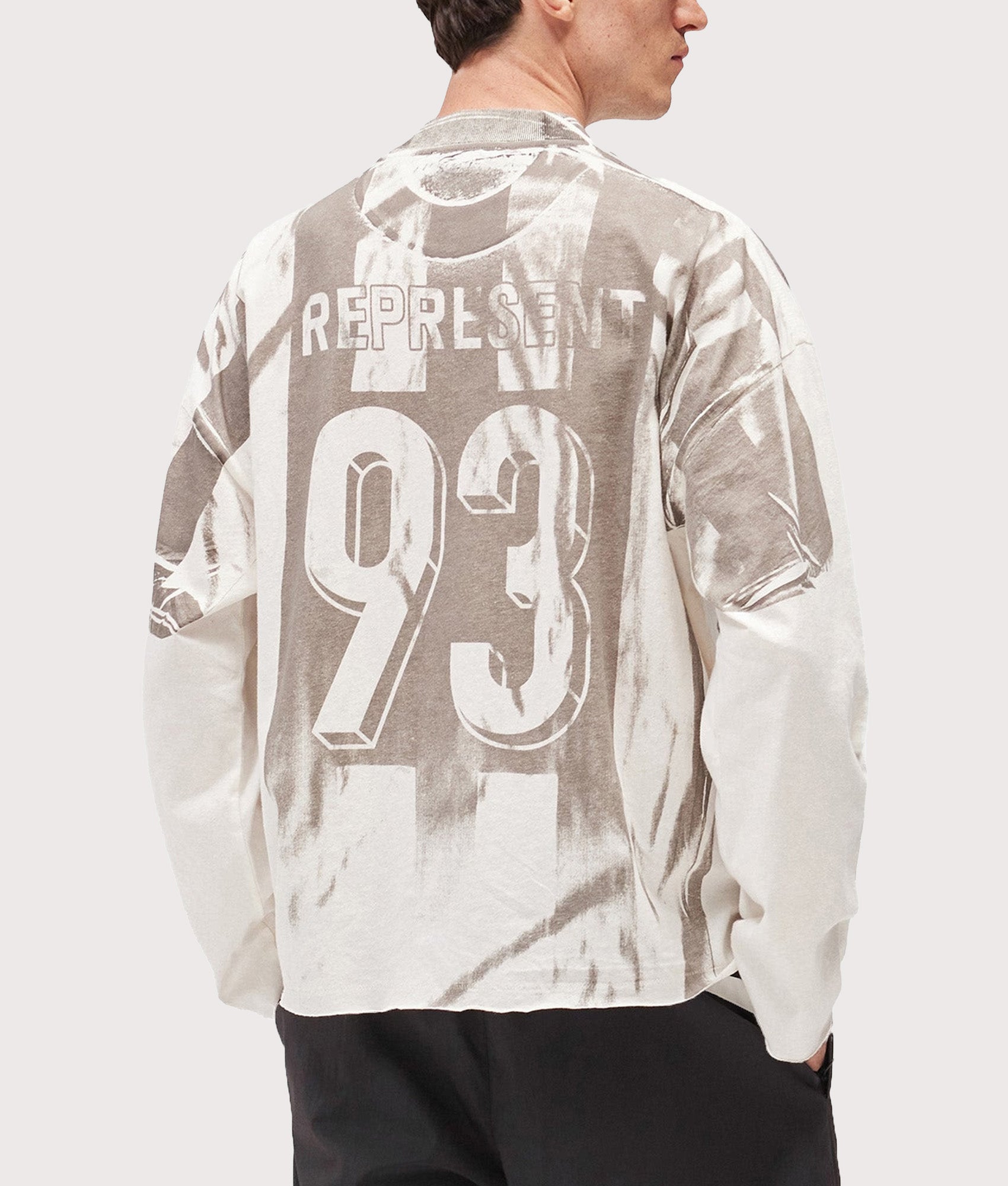 Represent Oversized Fit Printed LS Football Top in Flat White at EQVVS Menswear. Back shot.