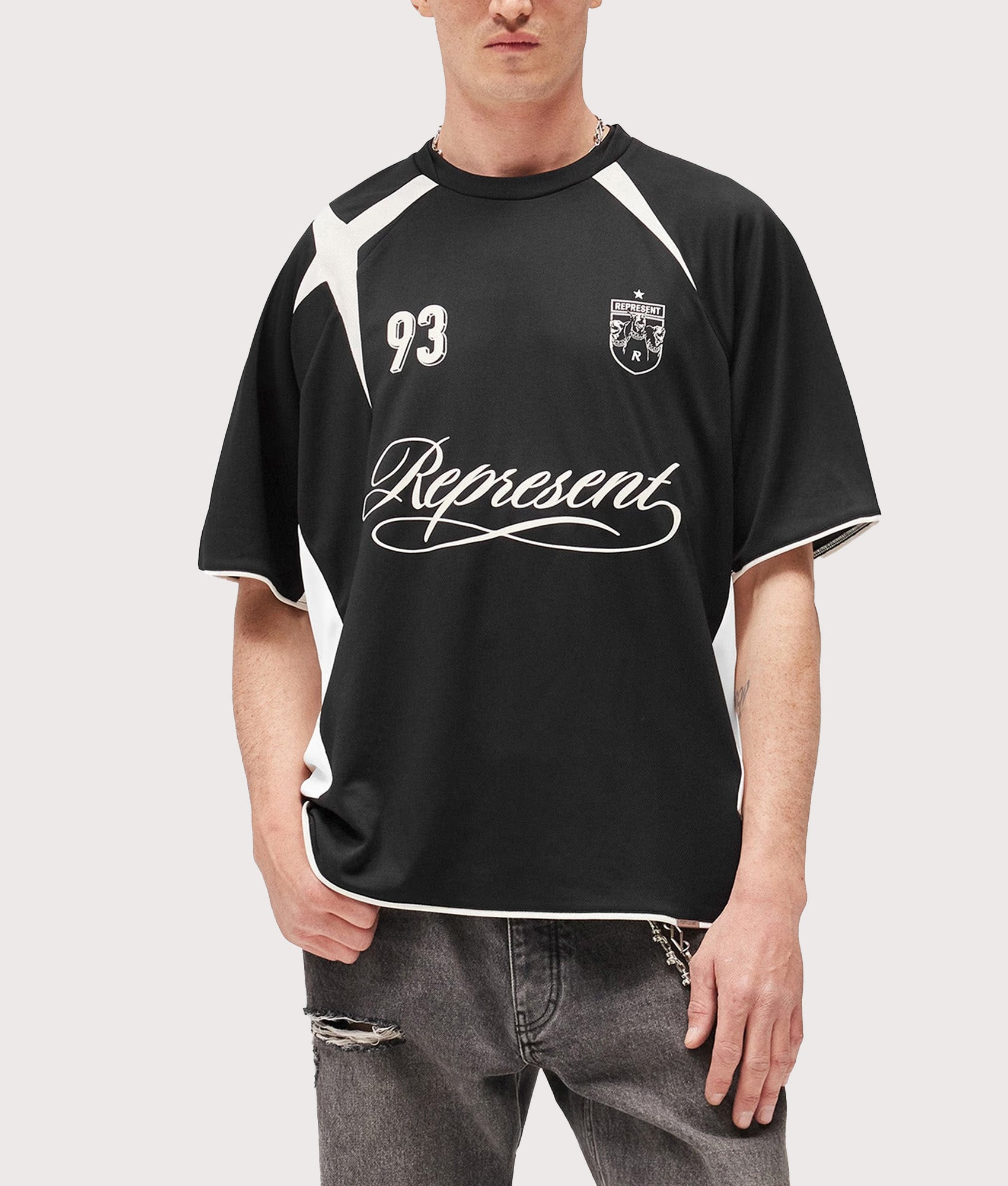 Represent Oversized Star Football Top in Jet Black at EQVVS Menswear. Model front shot.