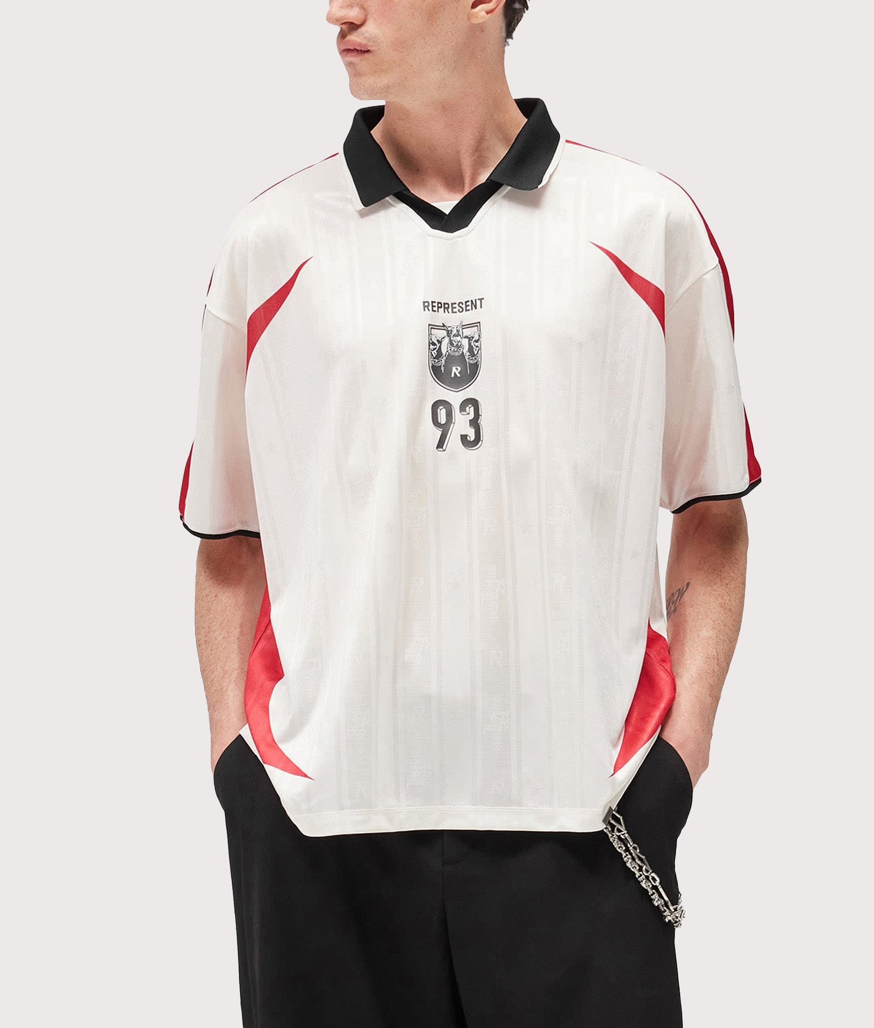 Represent Oversized Fit Spike Football Top in Flat White at EQVVS Menswear. Model front shot.