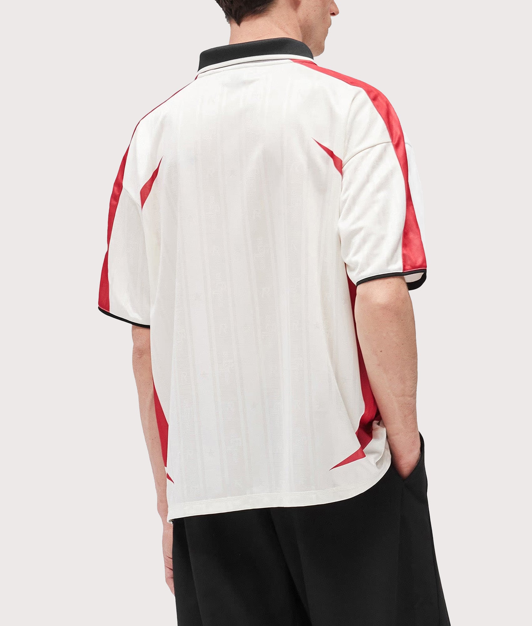 Represent Oversized Fit Spike Football Top in Flat White at EQVVS Menswear. Model back shot.