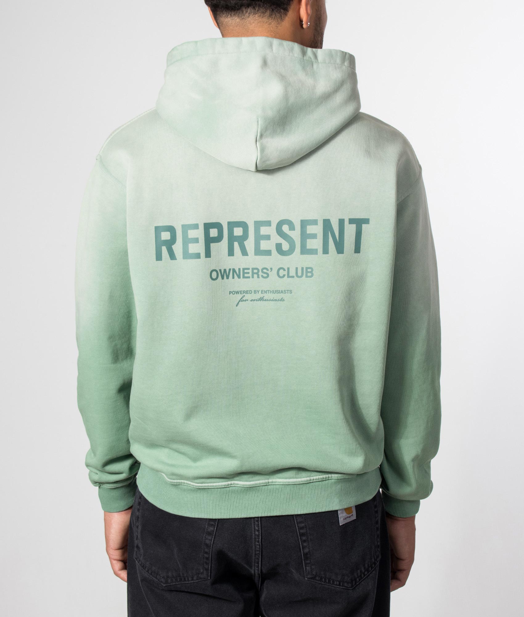 Represent Oversized Fit Represent Owners Club Hoodie in Washed Aloe at EQVVS Menswear. Model back shot.