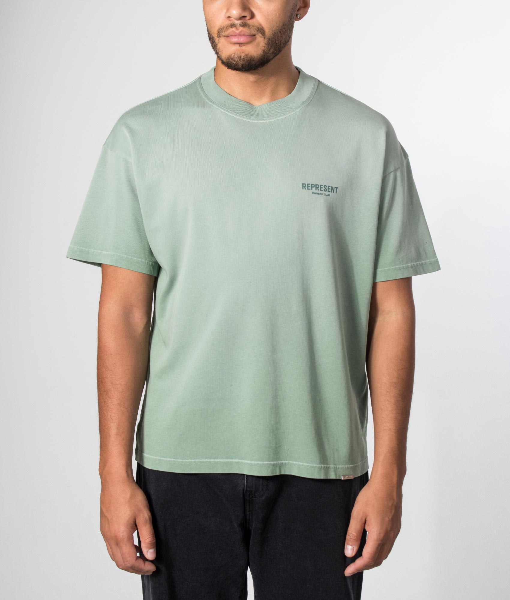 Represent Oversized Fit Represent Owners Club T-Shirt in Washed Aloe at EQVVS Menswear. Model front shot.