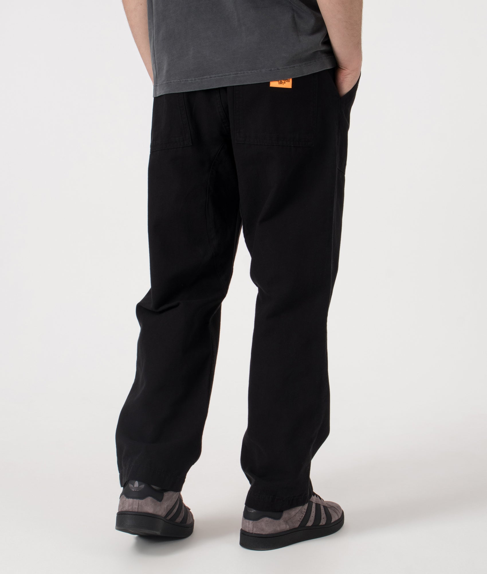 Service Works Regular Fit Canvas Chef Pants in Black at EQVVS Menswear. Model back shot.