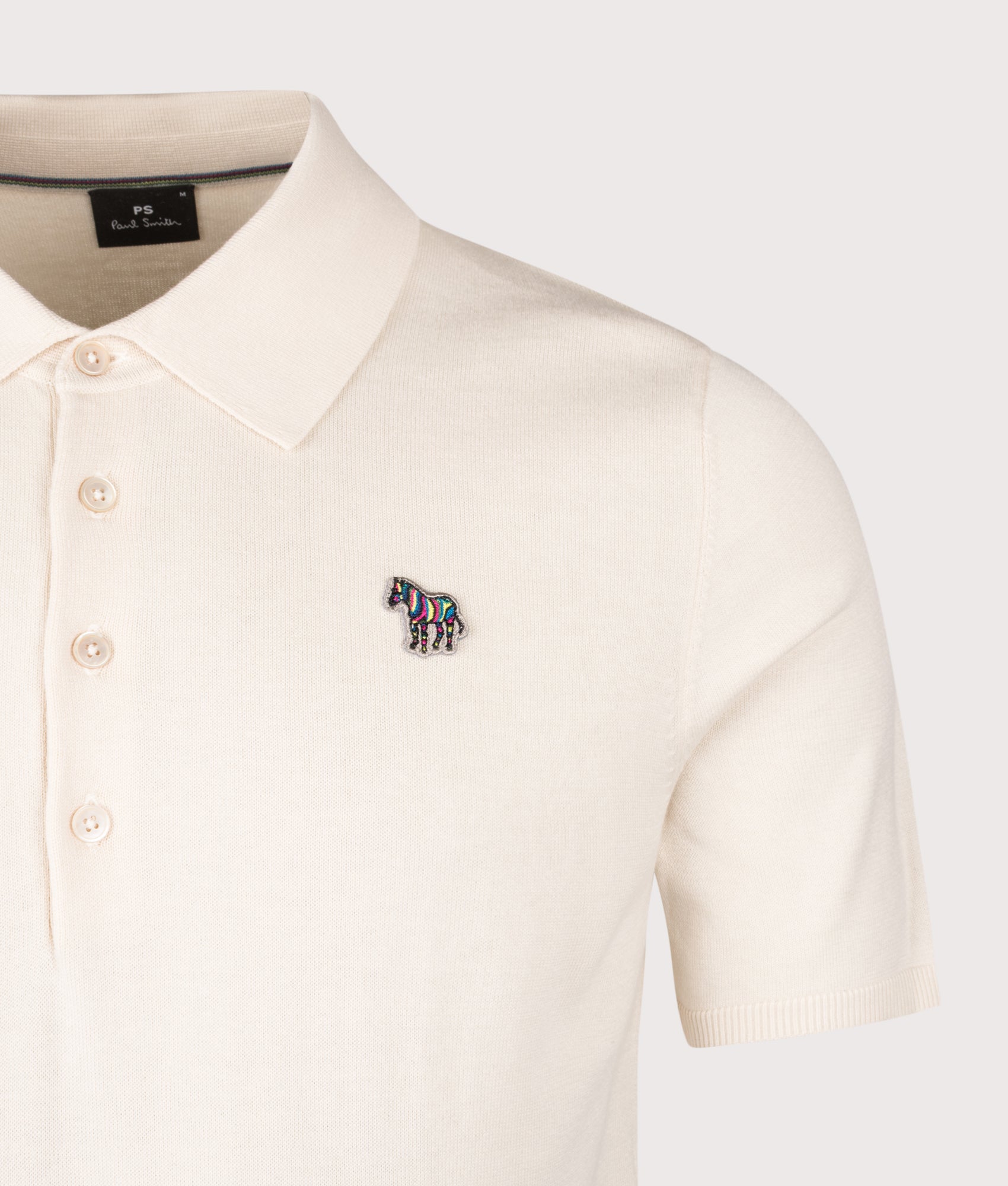 PS Paul Smith Zebra Badge Polo Shirt in White at EQVVS Menswear. Detail shot.