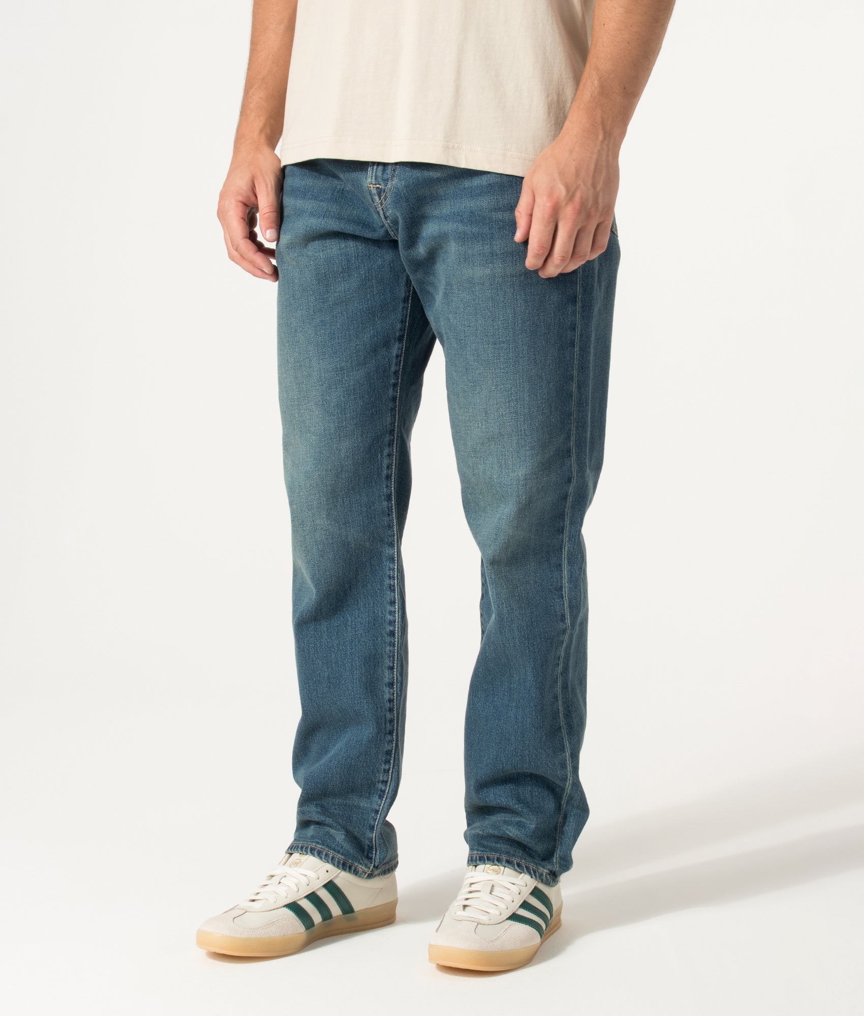 PS Paul Smith Relaxed Tapered Fit Jeans in Vintage Wash at EQVVS Menswear. Angled model front shot.