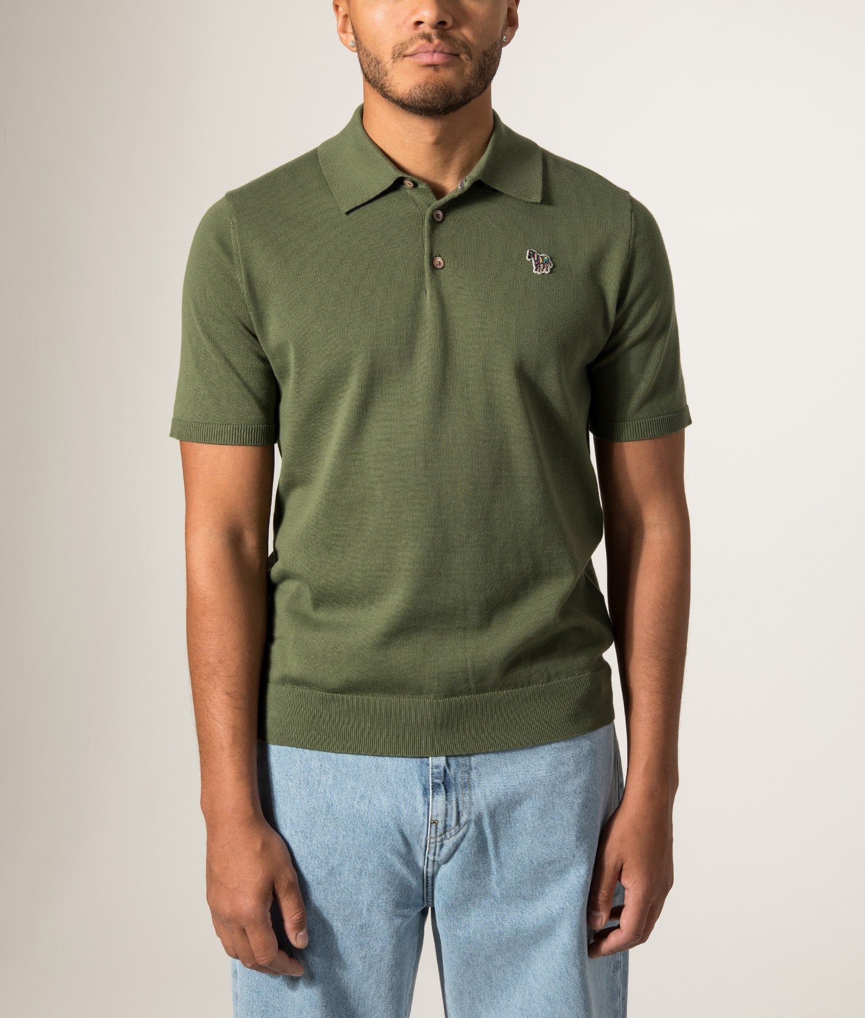 PS Paul Smith Regular Fit Zebra Badge Knitted Polo Shirt in Military Green at EQVVS Menswear. Model front shot.