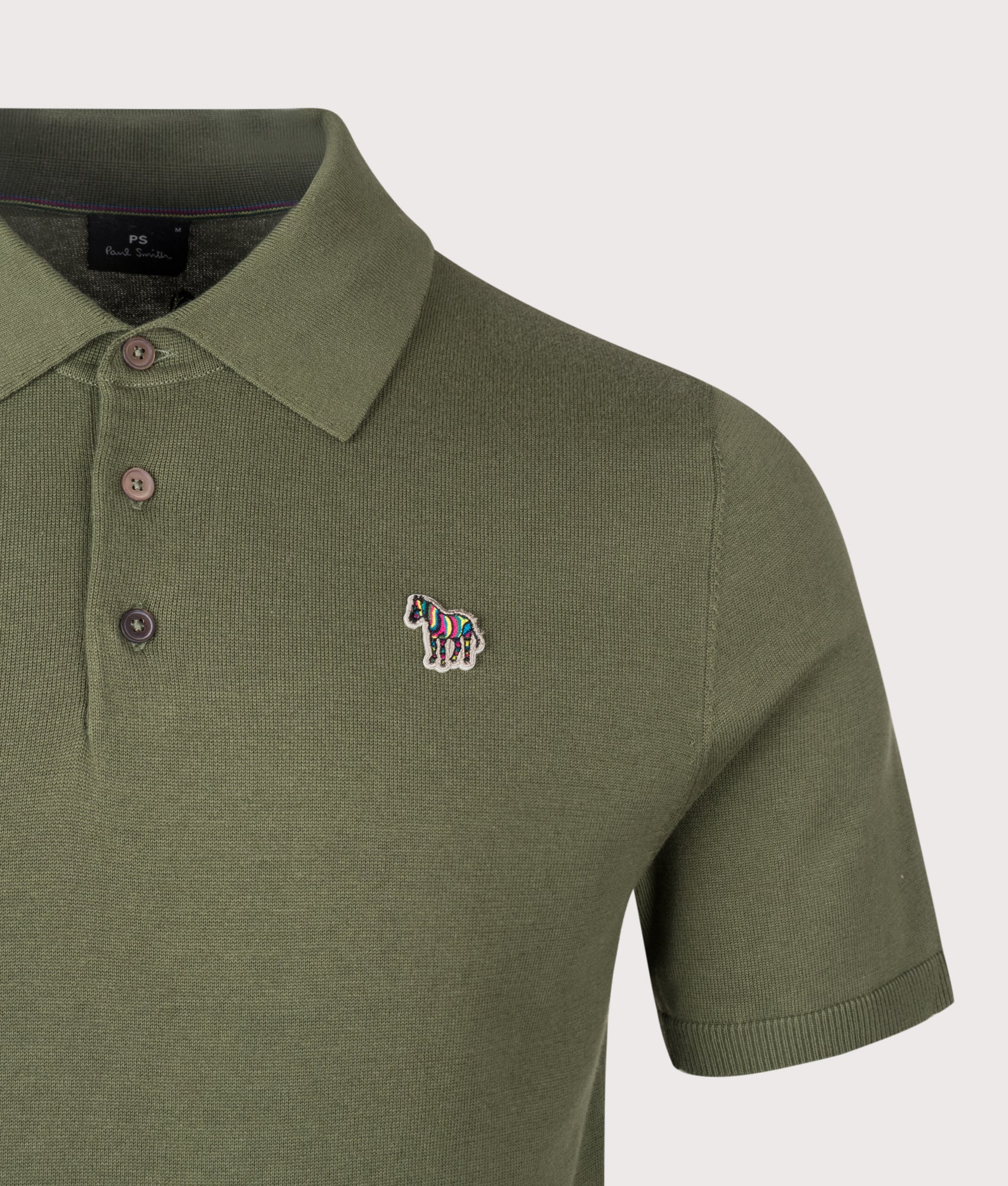 PS Paul Smith Regular Fit Zebra Badge Knitted Polo Shirt in Military Green at EQVVS Menswear. Detail shot.