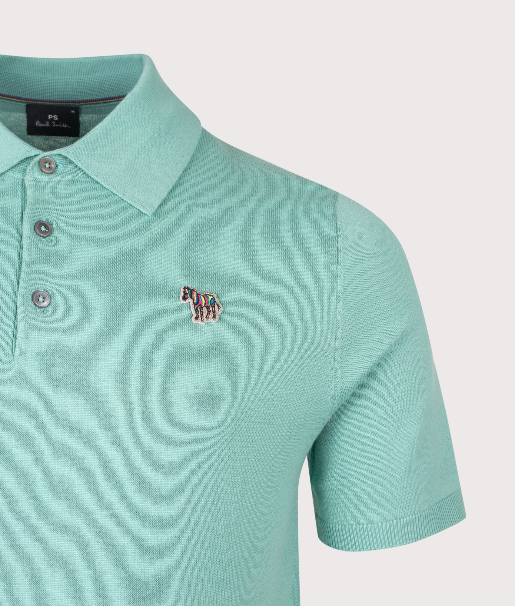 PS Paul Smith Regular Fit Zebra Badge Knitted Polo Shirt in Petrol Green at EQVVS Menswear. Detail shot.