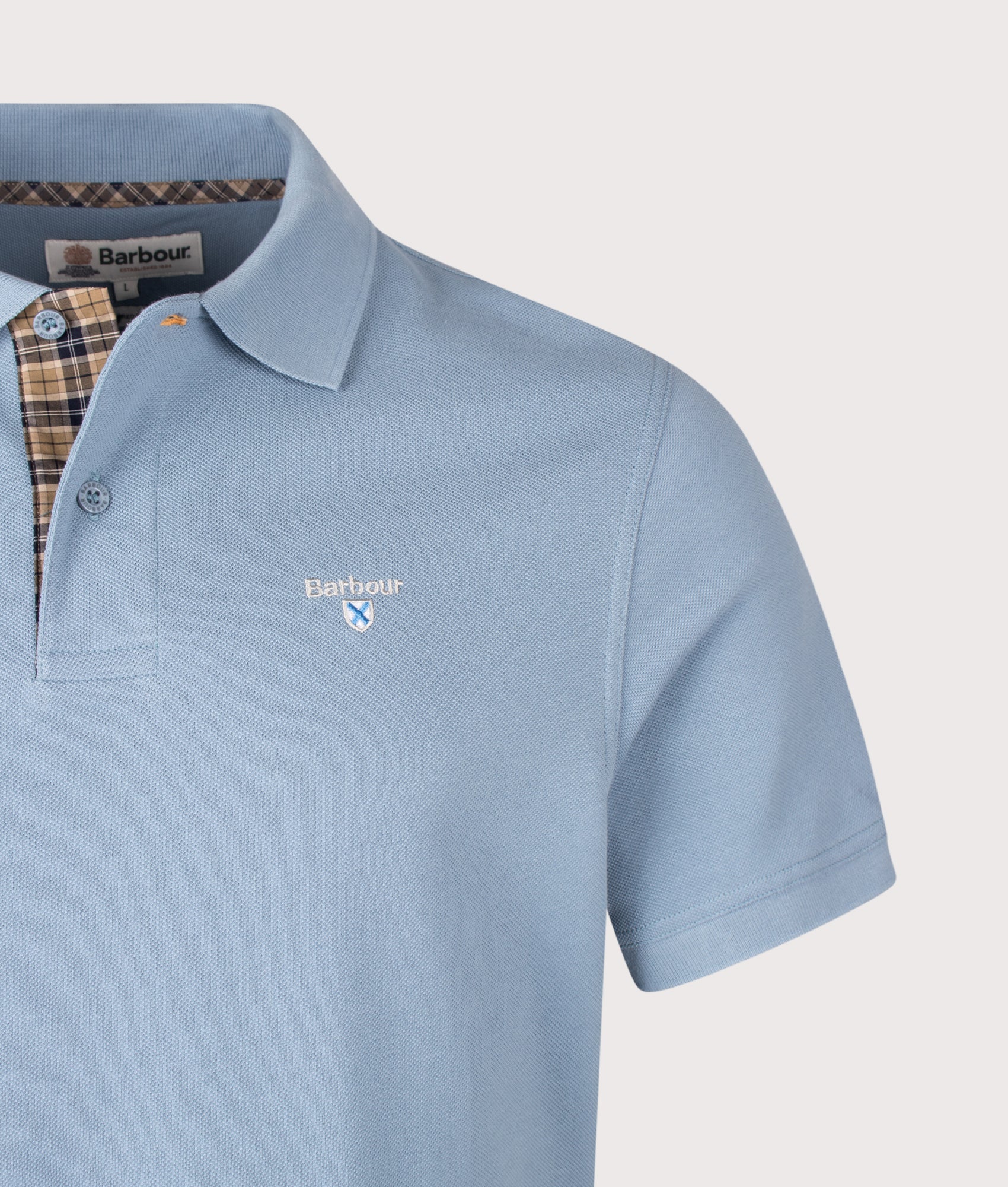 Barbour Tartan Pique Polo Shirt in Tarn Blue at EQVVS Menswear. Detail shot.