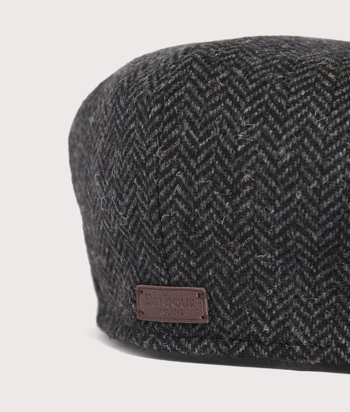Barbour Lifestyle Fyne Tweed Baker Boy Cap in Charcoal Grey herringbone tweed at EQVVS Menswear. Detail shot.