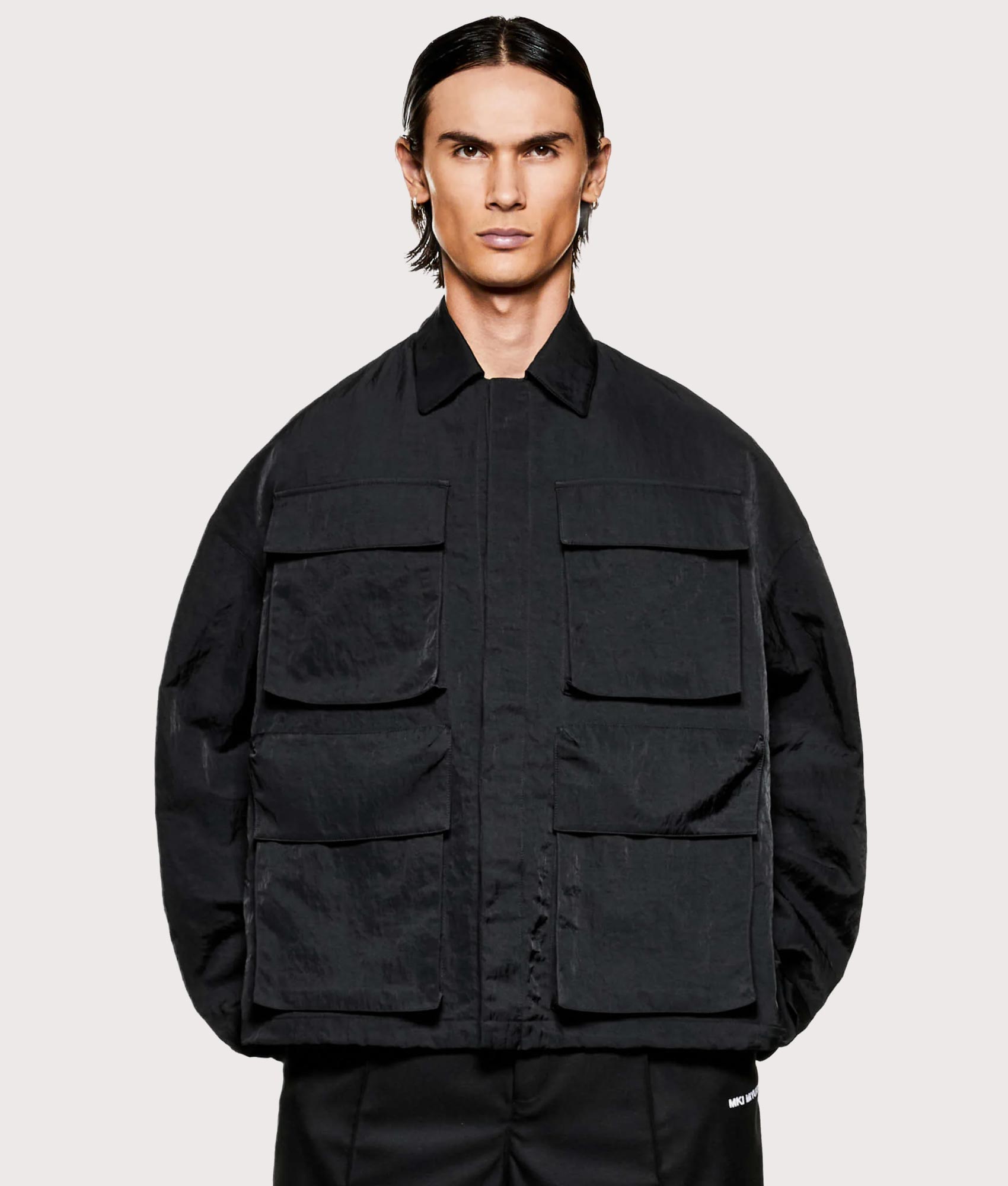 MKI MIYUKI ZOKU Silky nylon box overshirt in black at EQVVS Menswear. Model front shot.