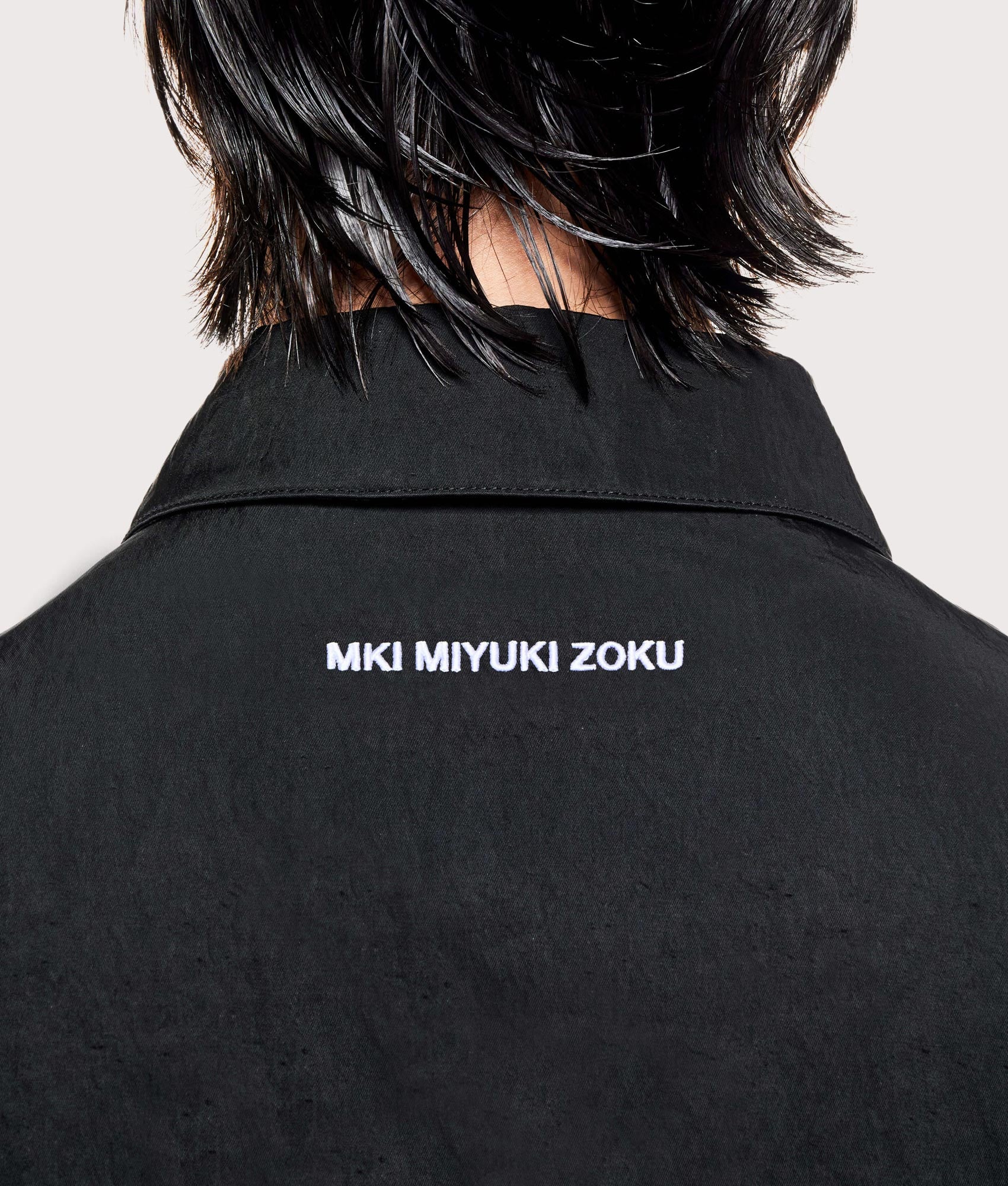 MKI MIYUKI ZOKU Silky nylon box overshirt in black at EQVVS Menswear. Back detail shot.