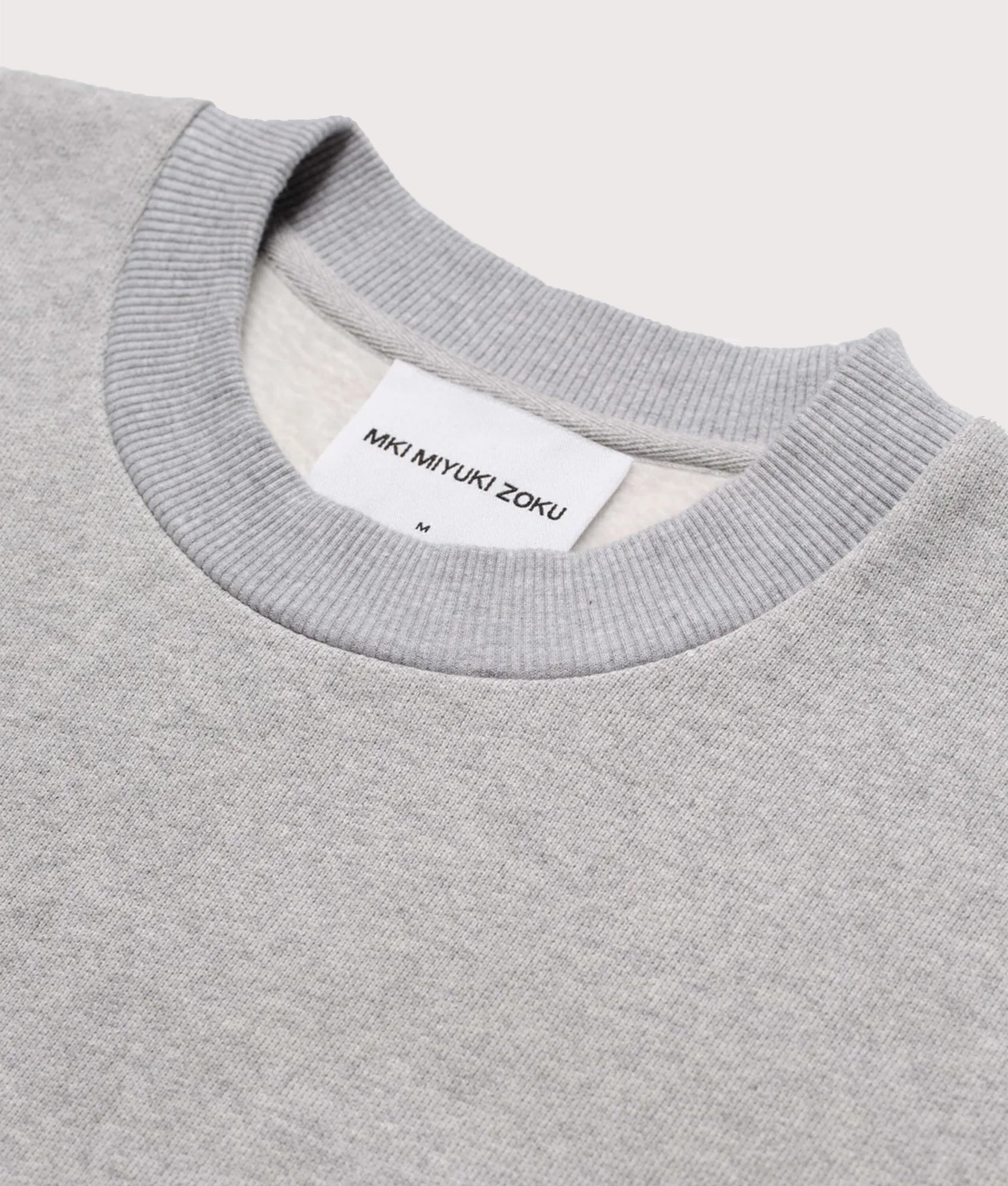 MKI MIYUKI ZOKU Oversized Uniform Crewneck Sweatshirt in grey at EQVVS Menswear. Neck line detail front shot.